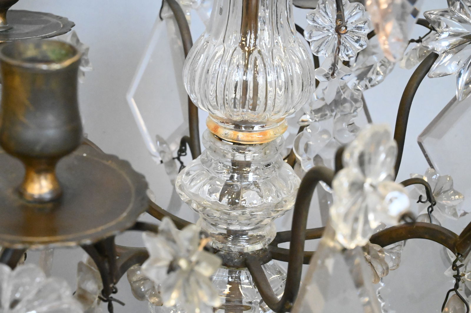 Pair of Louis XV Bronze and Cut Glass Girandoles: Pair of Louis XV Bronze and Cut Glass Girandoles composed of a bronze foundation with a footed base supporting scrolling candle arms, each girandole fitted with four lights and hung with cut-glass