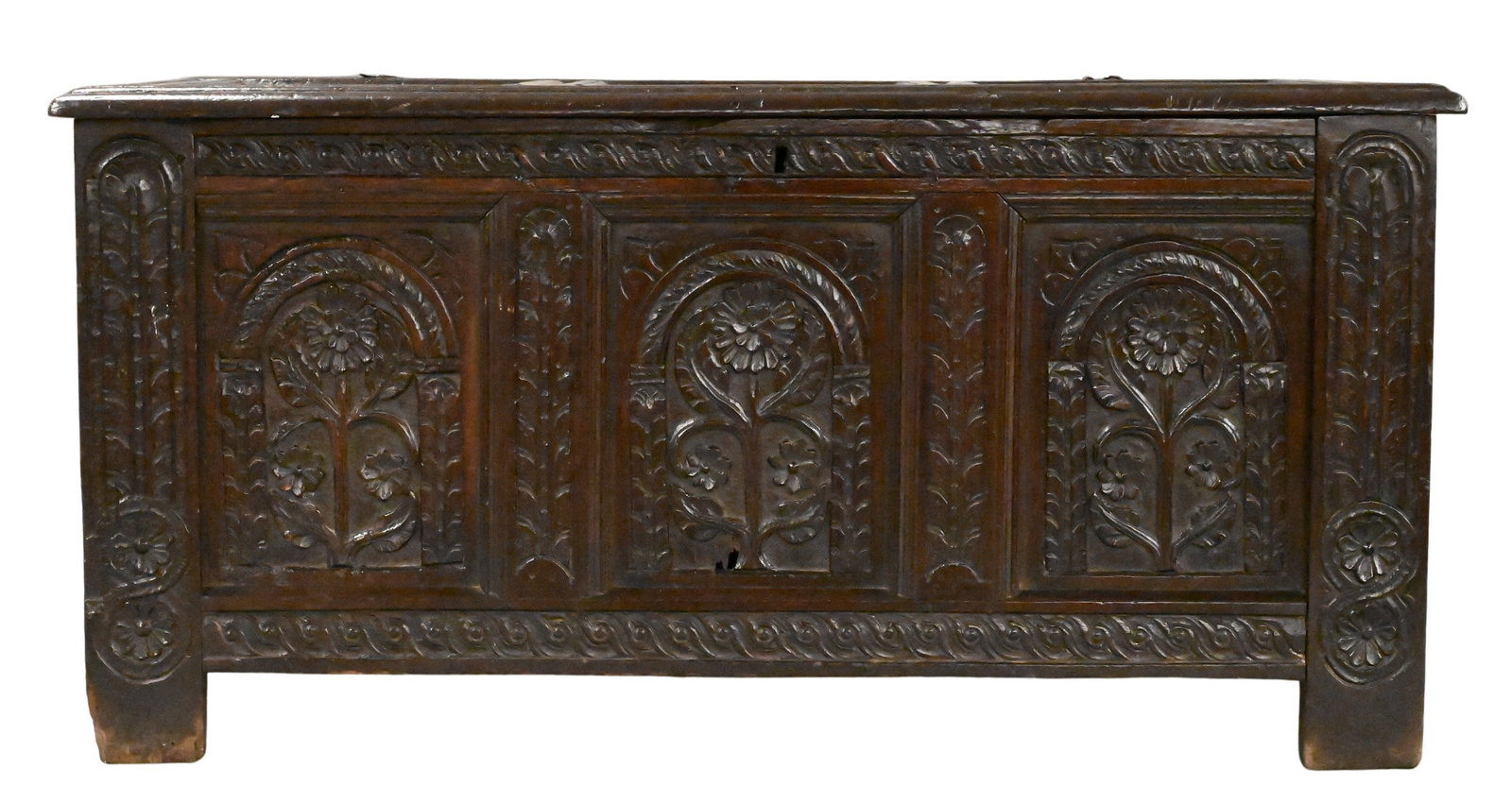 English Carved Oak Blanket Chest: English Carved Oak Blanket Chest rectangular hinged lid opening to a fitted interior, the front three carved panels depicting stylized sunflowers in arched reserves, flanked by muntins and carved rail
