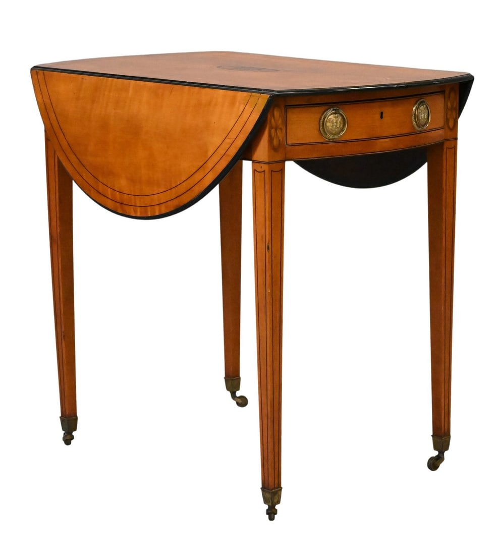 George III Ebony Inlaid-Satinwood Pembroke Table: George III Ebony Inlaid-Satinwood Pembroke Table oval twin-flap top above one real and one faux frieze drawer on square tapering legs terminating in brass caps and casters, bowed ends height 26 1/2 in