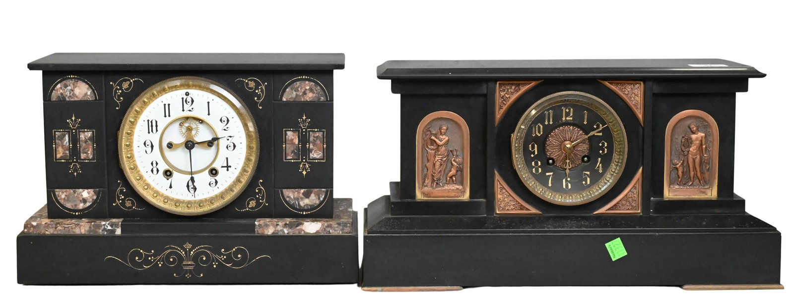 Two Slate Mantel Clocks: Two Slate Mantel Clocks Each having a rectangular black slate case, one featuring classical figural relief panels, the other featuring marble insets and gilt decoration, both having circular enamel