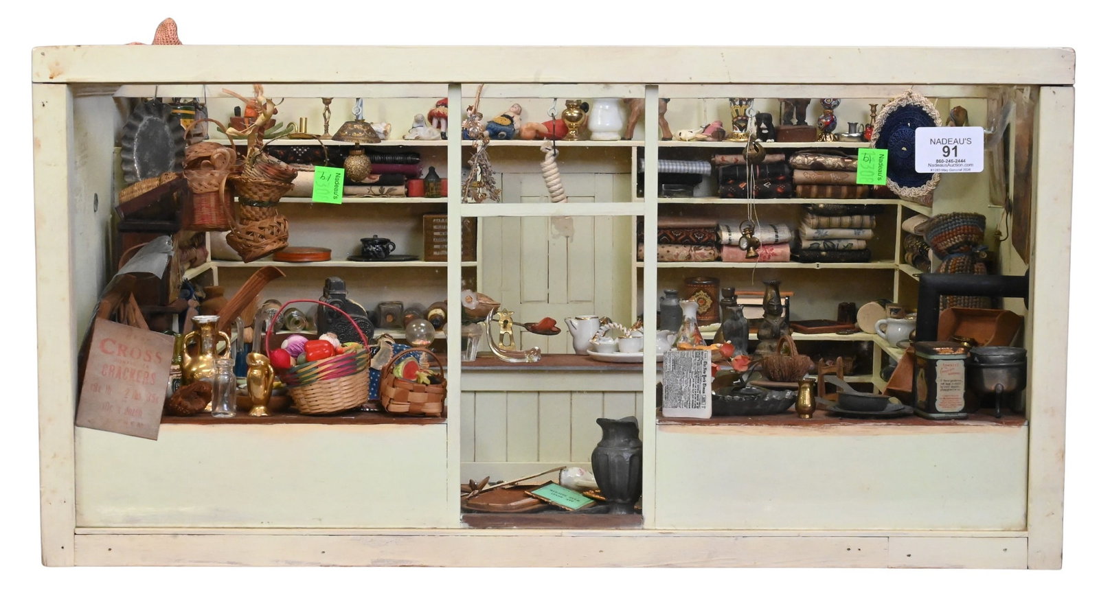 Miniature Dollhouse Diorama of a General Store: Miniature Dollhouse Diorama of a General Store housed in a custom glass-front display case. Finely detailed interior fitted with wall shelving, central counter, and upper ledges, all densely stocked