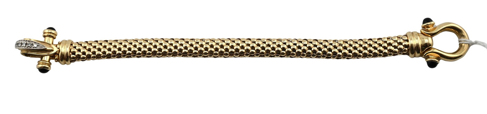 14K Yellow Gold, Diamond and Onyx Bracelet: 14K Yellow Gold, Diamond and Onyx Bracelet Textured tubular link bracelet terminating in decorative finials accented by cabochon onyx, the clasp set with small round diamonds in a stylized foliate mot