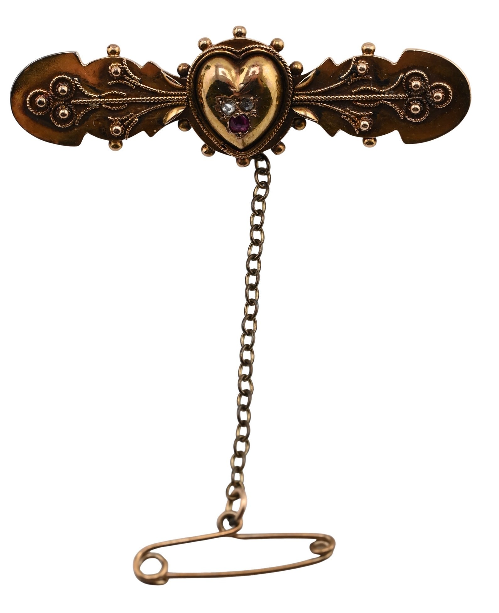15K Victorian Gold Heart Motif Bar Pin: 15K Victorian Gold Heart Motif Bar Pin having engraved foliate decoration centered by a heart motif, marked 15ct, retaining safety chain. length 1 3/4 inches total weight 3.9 grams
