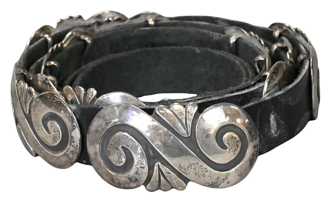 Debbie Alessandro (Native American, Navajo B.1957): Debbie Alessandro (Native American, Navajo B.1957) Navajo Dine Silver Concho Belt Sterling silver and leather belt featuring 9 sterling conchas Marked on underside DEB Length 55 inches Provenance: