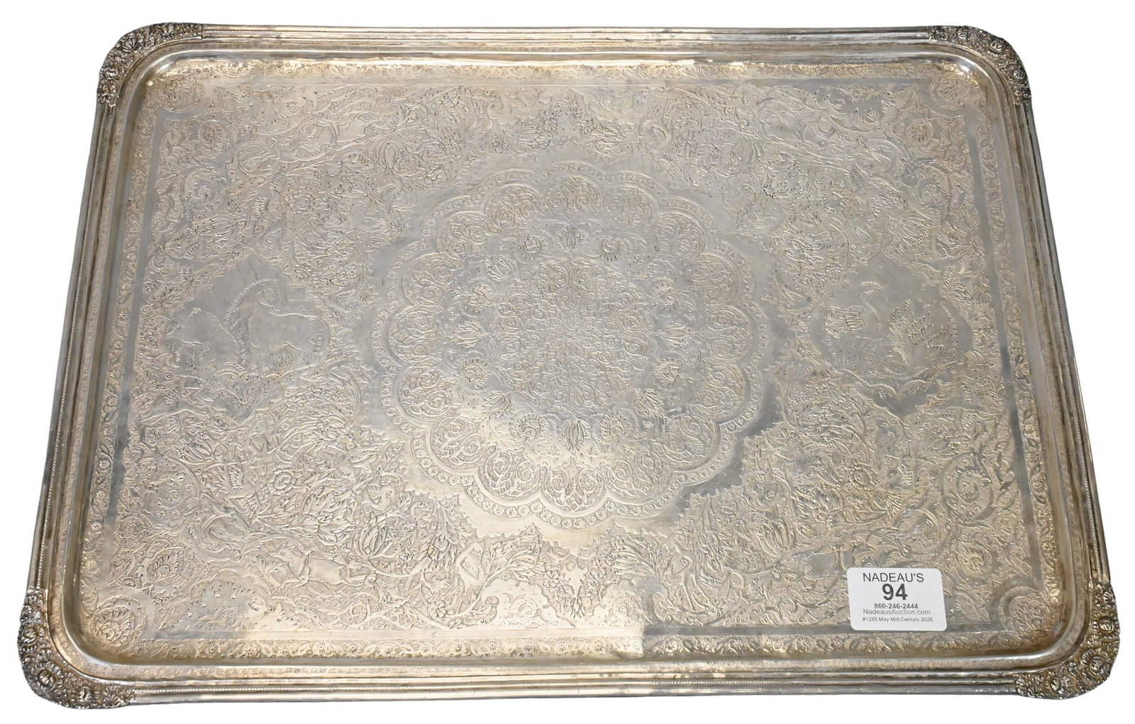 Large Persian / Iranian Chased Silver Tray: Large Persian / Iranian Chased Silver Tray having central mandala carved with intricate scroll and floral motifs, flanked by two images of animals, the field laced with more scrollwork floral, and
