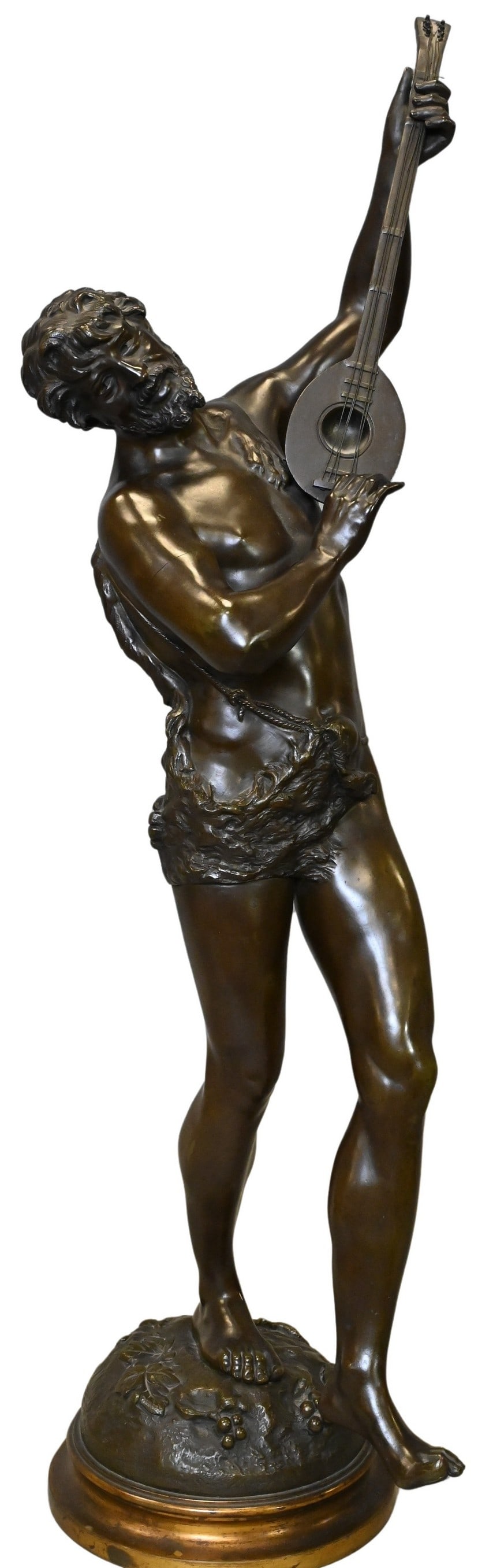 Victor Rousseau (Belgian 1865-1954): Victor Rousseau (Belgian 1865-1954) Male Bacchant Musician Patinated bronze on brass base depicting a figure in lion skin dancing and holding an instrument Signed Russeau Height 32 inches
