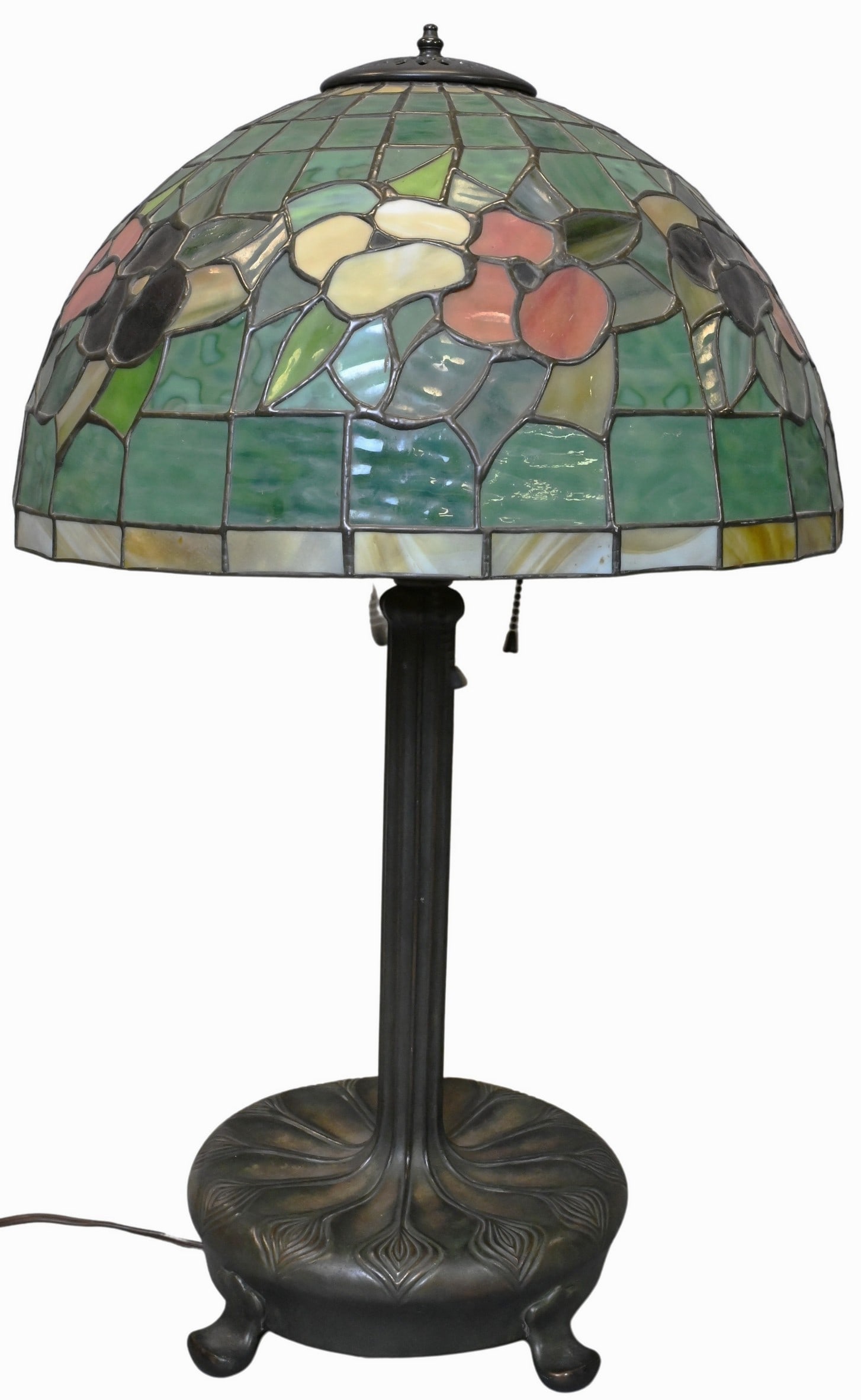 Tiffany Style Leaded Glass Table Lamp: Tiffany Style Leaded Glass Table Lamp Domed shade featuring polychrome floral decoration in a leaded matrix, above a geometric border, on a patinated metal base and four feet height 27 inches