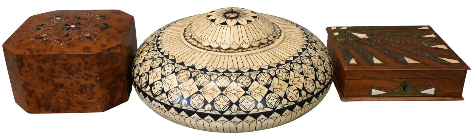 Three Decorative Covered Boxes: Three Decorative Covered Boxes to include a burlwood octagonal box having inlaid floral motif to the lid, a rectangular wood box having radiating metal and mother-of-pearl inlay, and a circular