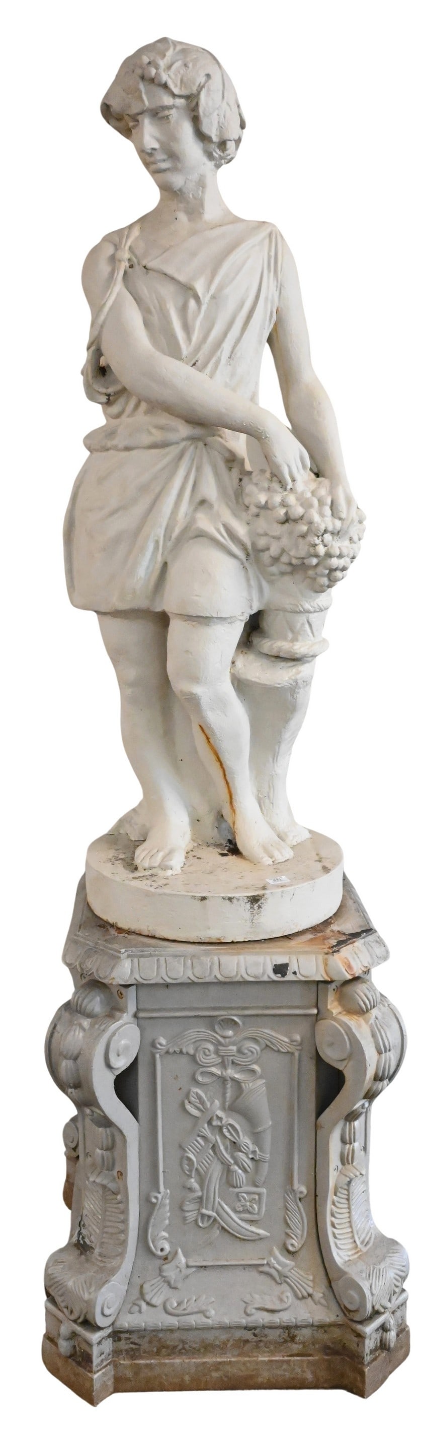 Outdoor Iron Neoclassical Figure Set on an Ornate Base: Iron Outdoor Neoclassical Figure Set on Ornate Base depicting a male figure harvesting grapes height 54 inches, base 22" x 22", height 32 inches