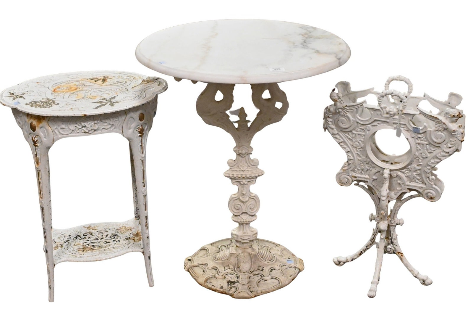 Three Outdoor Victorian Cast Iron Pieces: Three Outdoor Victorian Cast Iron Pieces in include marble top center table, a figural newspaper stand, along with decorative two-tier side table table height 28 inches