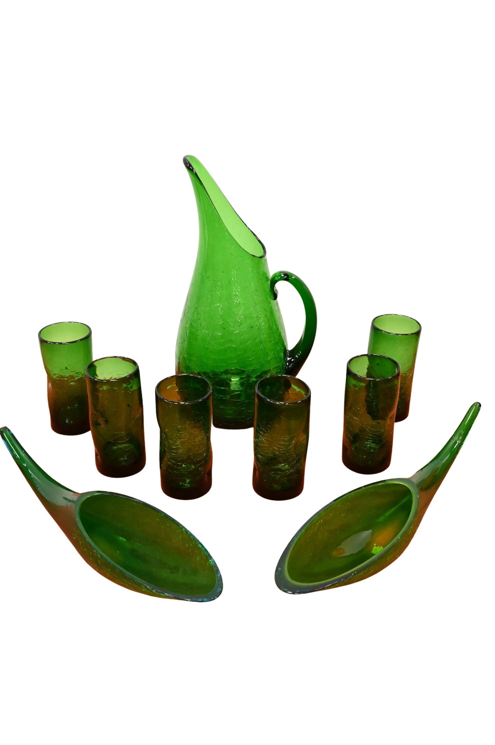 Nine Piece Blenko Green Crackle Glass Group: Nine Piece Blenko Green Crackle Glass Group to include a tall pitcher having an applied handle and flared spout, six drinking glasses, along with two Winslow Anderson "Horn of Plenty" elongated freefo