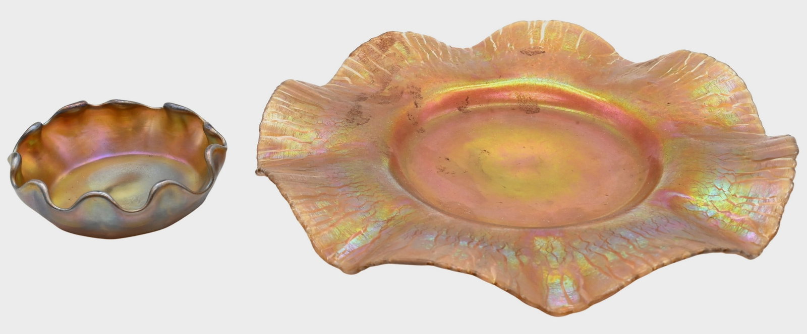Two Piece Tiffany Studios Favrile Glass Lot: Two Piece Tiffany Studios Favrile Glass Lot to include gold iridescent ruffled rim plate having onion skin pattern, signed on underside L.C.T 1263 along with small ruffled edge finger bowl signed