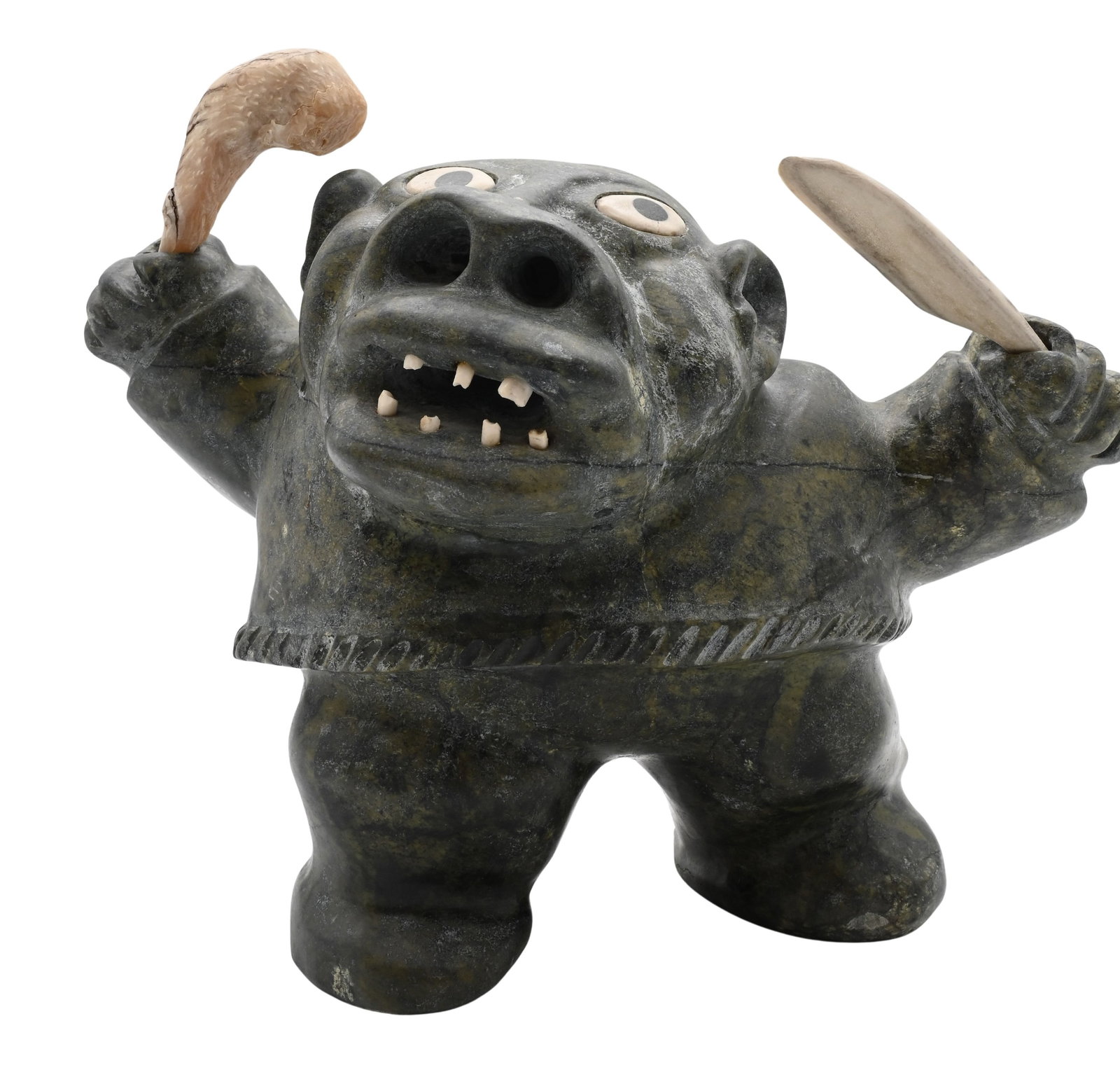 Nelson Takkiruq (Canadian Inuit, Gjoa Haven 1930-1999): Nelson Takkiruq (Canadian Inuit, Gjoa Haven 1930-1999) Spirit Hunter or Drummer Figure Carved green stone sculpture depicting a crouching figure having inset eyes and an open mouth showing teeth, hold