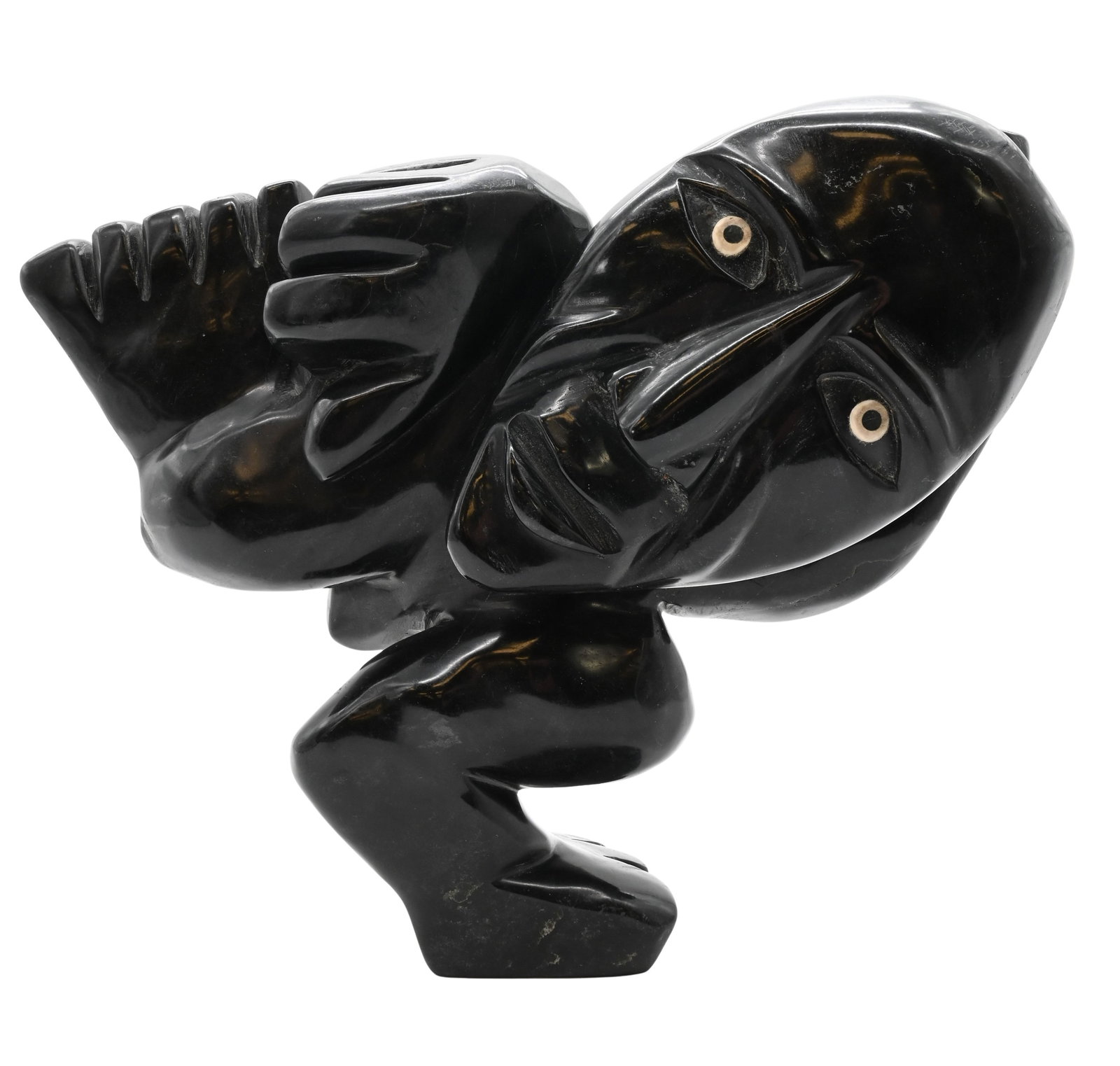 Toonoo Sharky (Canadian Inuit, Cape Dorset B.1970): Toonoo Sharky (Canadian Inuit, Cape Dorset B.1970) "Transition", 1995 Carved black soapstone sculpture depicting a crouching figure transforming into a bird, having incised features and inset eyes Sig