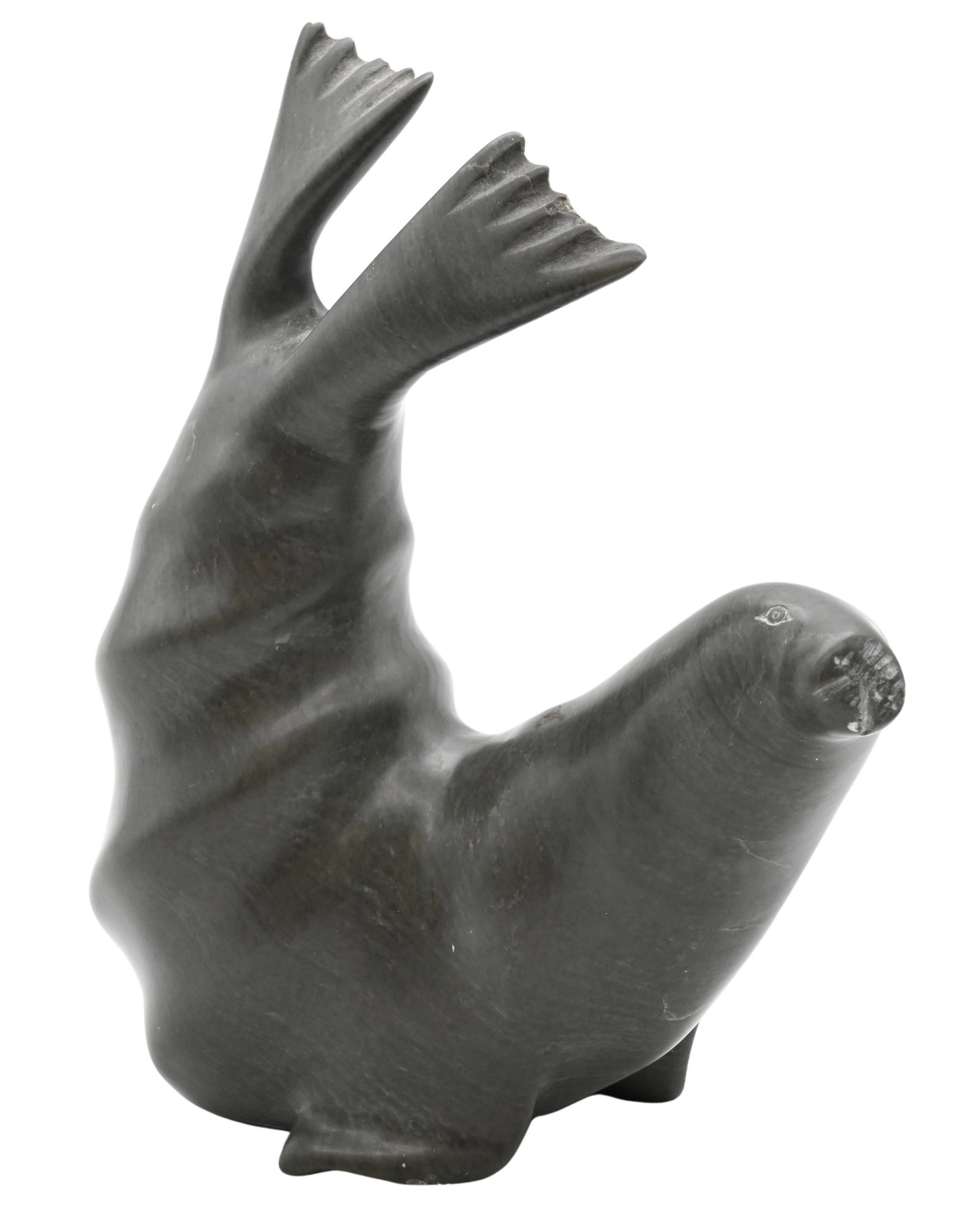 Nuna Parr (Canadian Inuit, Cape Dorset 1949-2026): Nuna Parr (Canadian Inuit, Cape Dorset 1949-2026) Seal with Tail Lifted, circa 1980 Carved soapstone Signed to underside Nuna Parr Height 5 1/2 inches