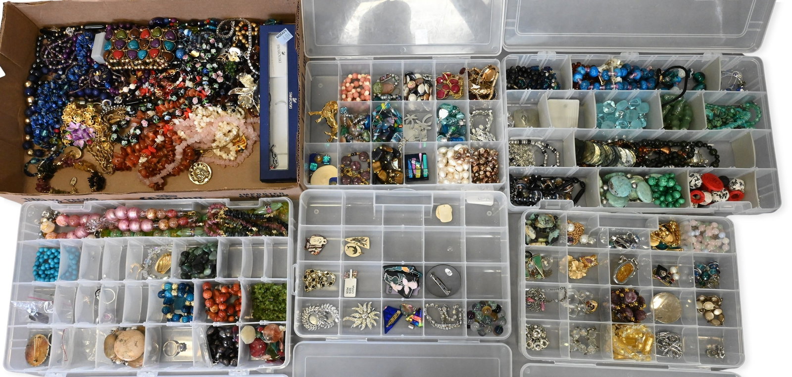 Large Group of Costume Jewelry: Large Group of Costume Jewelry To include assorted necklaces, rings, bracelets, earrings, and pins/brooches, having a variety of semi precious gemstones and glass. Some brands include Monet, Swarovski