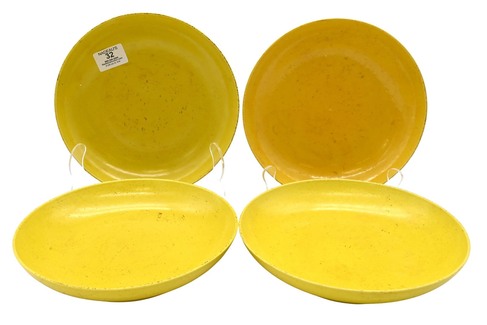 Four Chinese Kangxi Style Lemon Yellow Porcelain Plates: Four Chinese Kangxi Style Lemon Yellow Porcelain Plates in bright lemon-yellow glaze, the undersides bearing six-character and seal underglaze blue marks, Circular form with recessed bases and glazed 