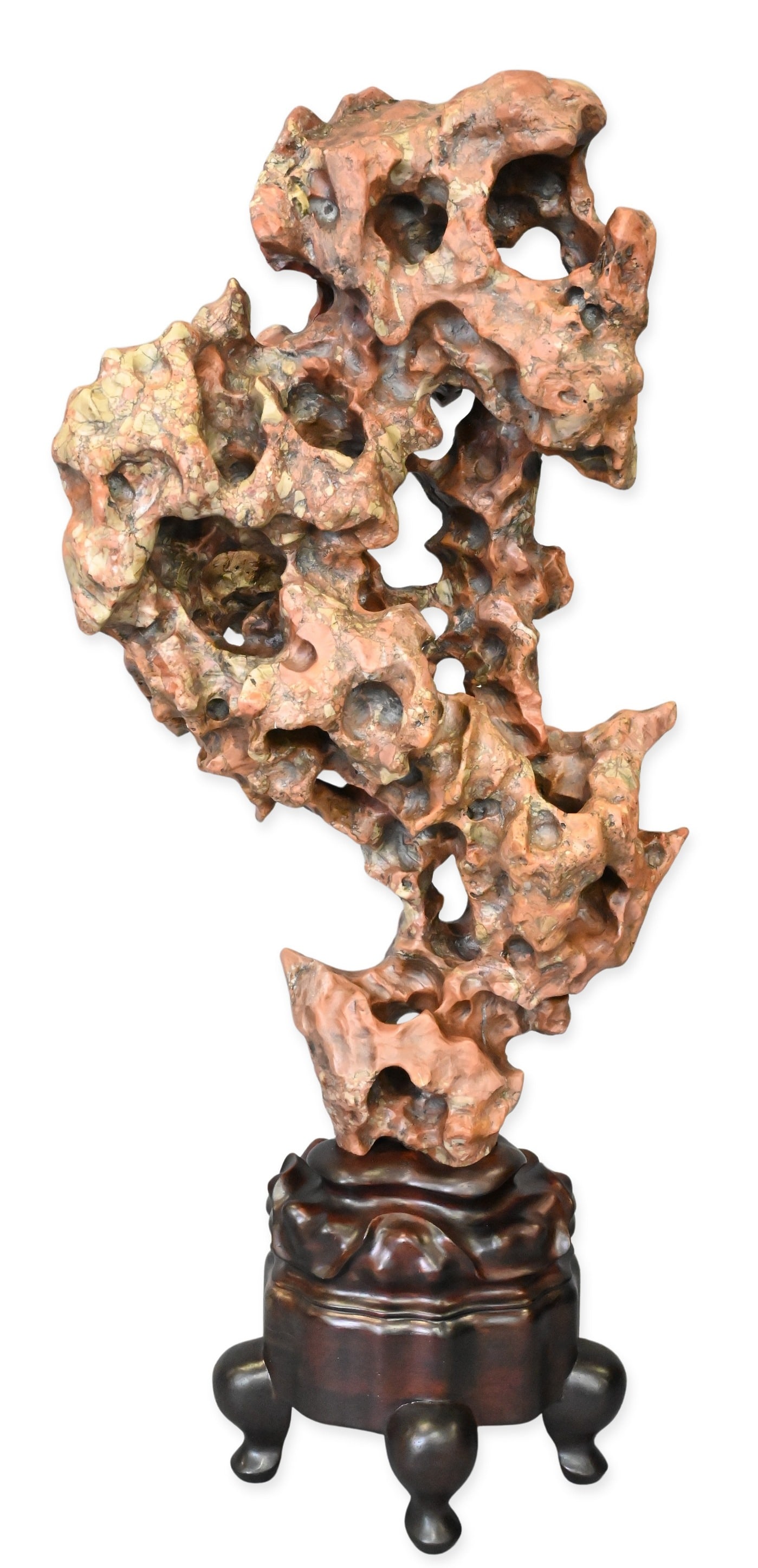 Chinese Scholar's Rock or Gongshi: Chinese Scholar's Rock or Gongshi the naturally perforated stone displaying dramatic peaks, cavities, and weathered surfaces, mounted on a carved hardwood pedestal stand raised on scroll feet. stone h