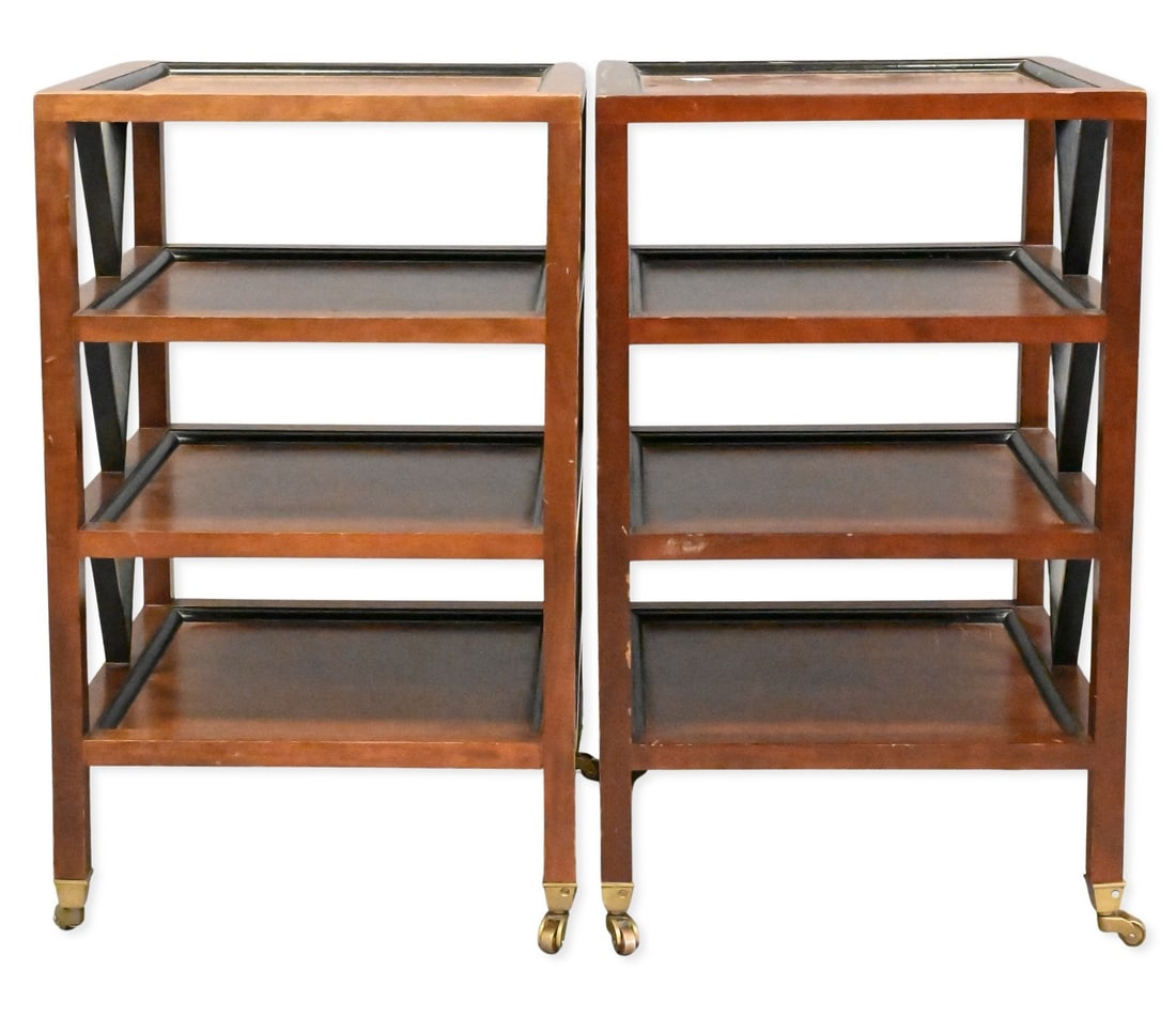 Pair of Campaign Style Rolling End Tables: Pair of Campaign Style Rolling End Tables walnut-finished end tables, each having a square top above three open shelves and black accent details, raised on casters. Height 23 inches, top 14" x 14"