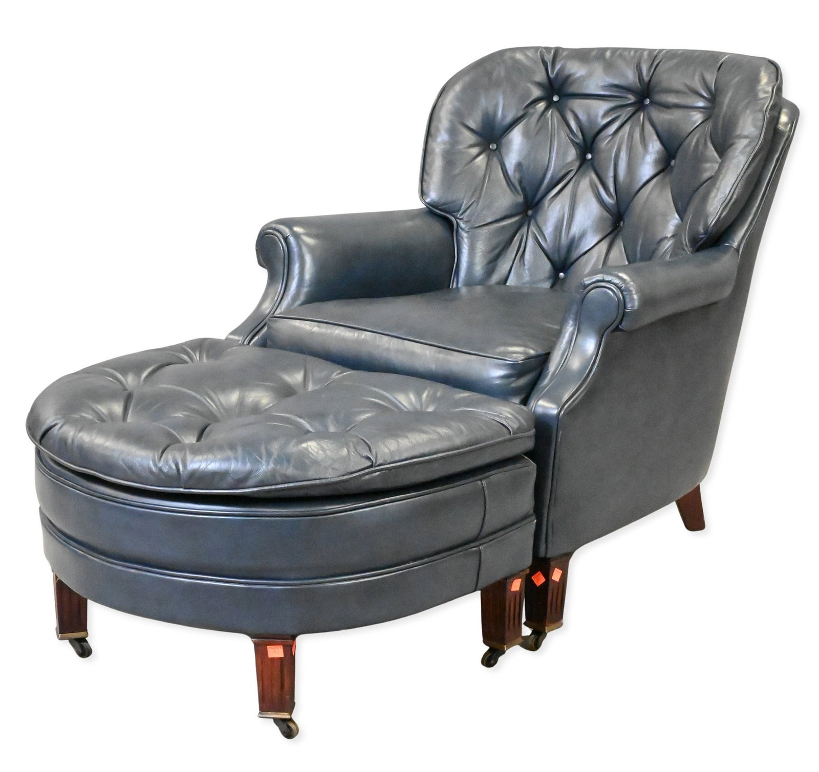 Blue Leather Tufted Easy Chairs and Ottoman: Blue Leather Tufted Easy Chairs and Ottoman ottoman on brass casters height 33 inches, width 31 inches