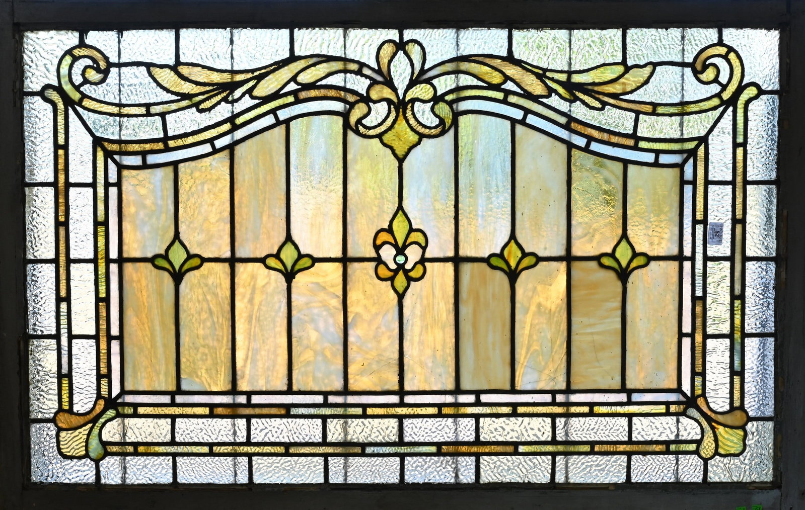 Leaded and Stained Glass Window: Leaded and Stained Glass Window rectangular architectural panel featuring Art Nouveau style scrolling foliate ornament and stylized floral motifs, set with caramel and cream slag glass bordered by tex