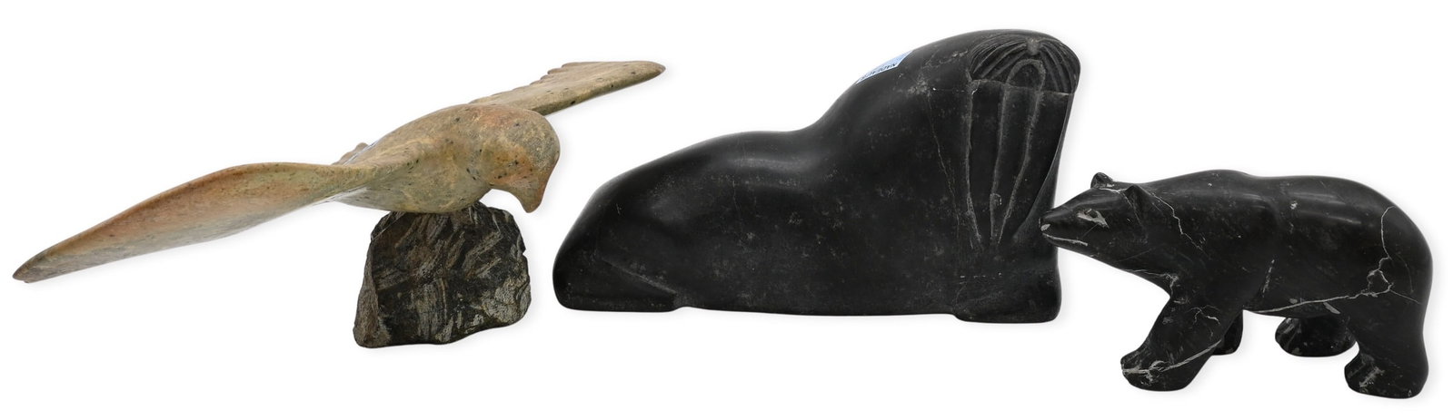 Three Inuit Animal Soapstone Carvings: Three Inuit Animal Soapstone Carvings to include Johnny Kasudluak (Canadian Inuit 20th Century) "Walrus", 1978 Carved black soapstone Signed and dated to underside in Inuktitut, along with Iglo Tag Tr