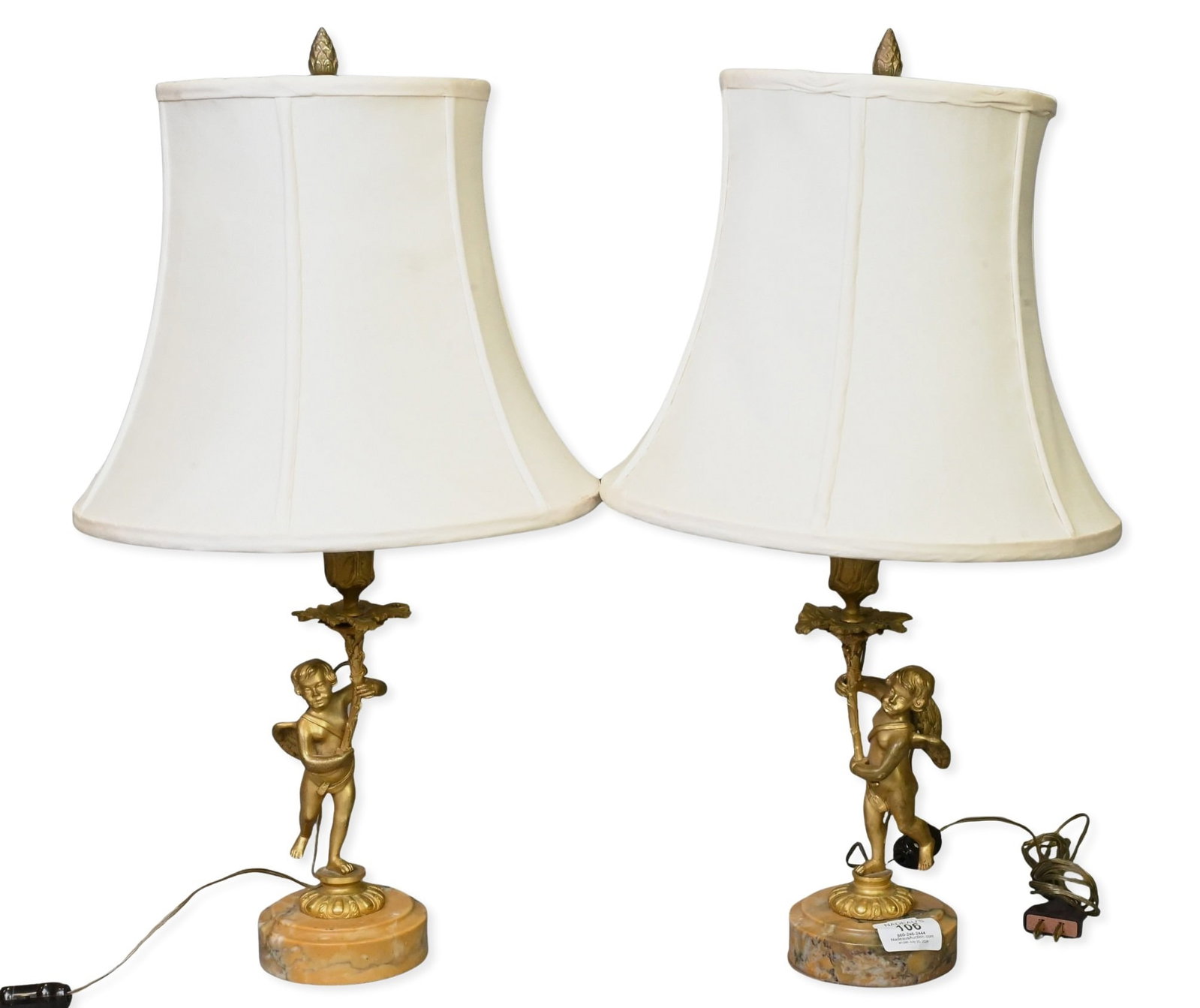 Pair of Bronze Dore Candlesticks Now Mounted as Lamps: Pair of Bronze Dore Candlesticks Now Mounted as Lamps each having cherubs set on round marble bases height 21 inches