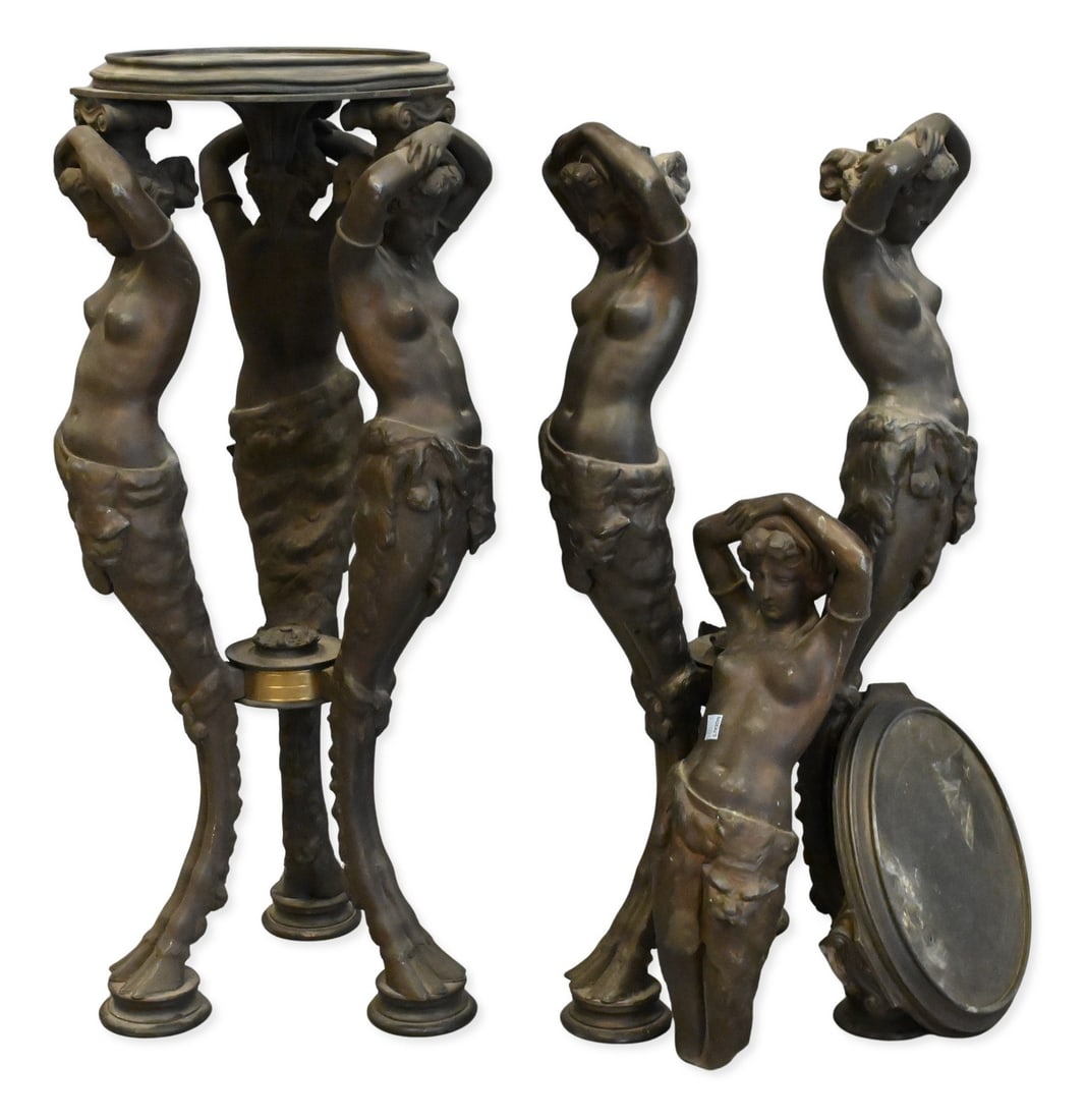 Pair of Figural Metal Torchère Stands, Early 20th Century: Pair of Figural Metal Torchère Stands, Early 20th Century each occasional table modeled as a classical female figure standing on cloven hooved supports, arms raised to support a circular platform, de