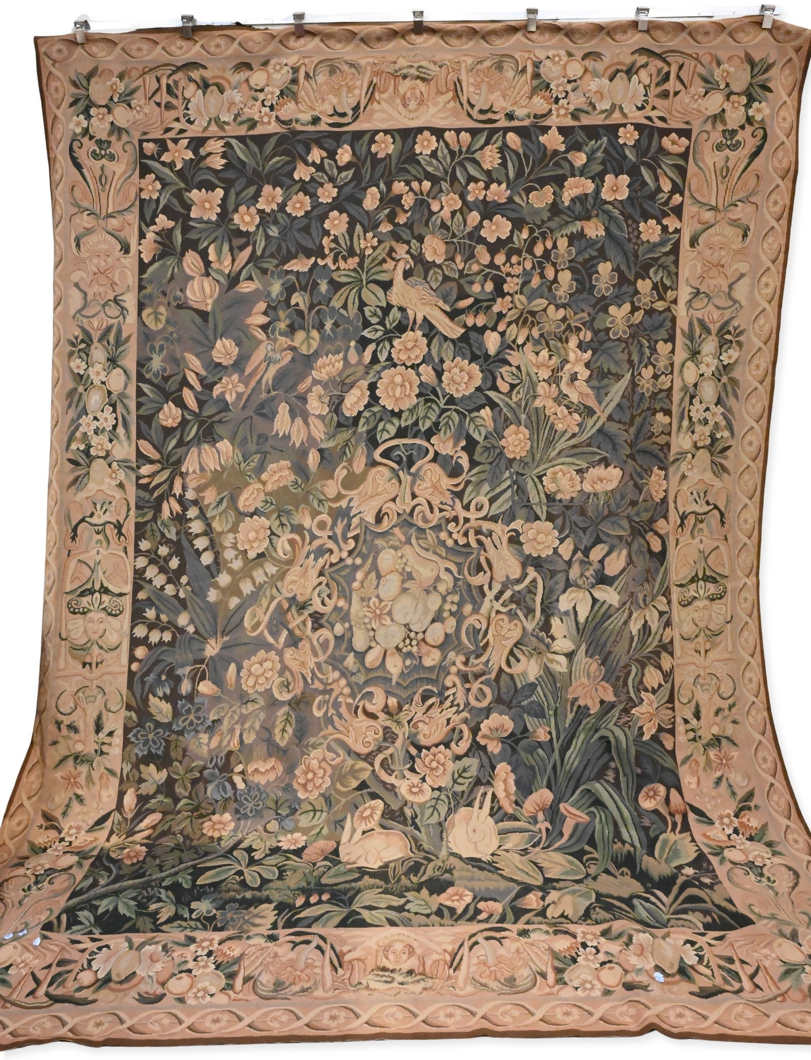 Flemish Style Hunt Scene Tapestry: Flemish Style Hunt Scene Tapestry needlepoint tapestry depicting a lively hunt scene with riders, hounds, and game animals set within a wooded landscape and distant village. The composition enclosed