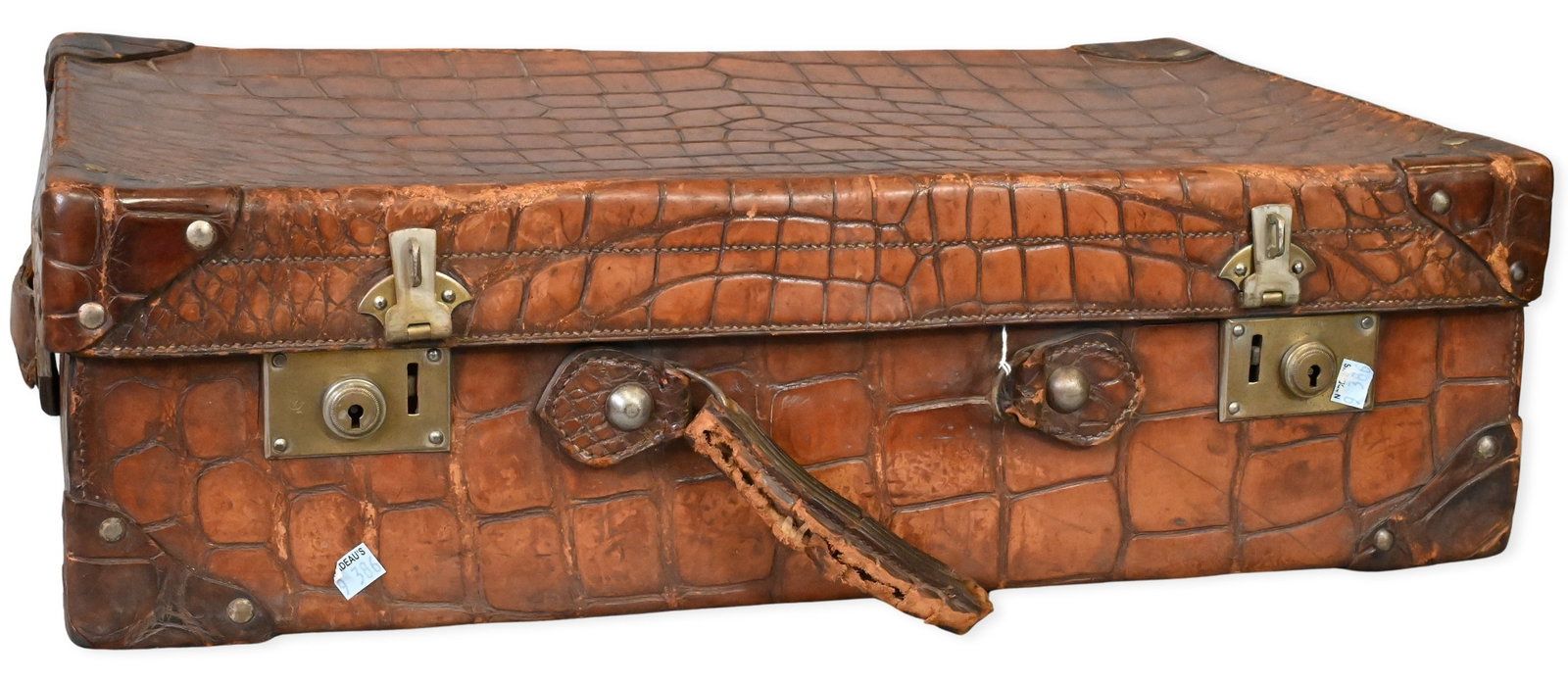 Vintage Crocodile Leather Suitcase: Vintage Crocodile Leather Suitcase traveling case having brass locks and hardware, leather handle, and fitted silk-lined interior compartment, made in Britain, torn handle 16" x 25", depth 7 inches