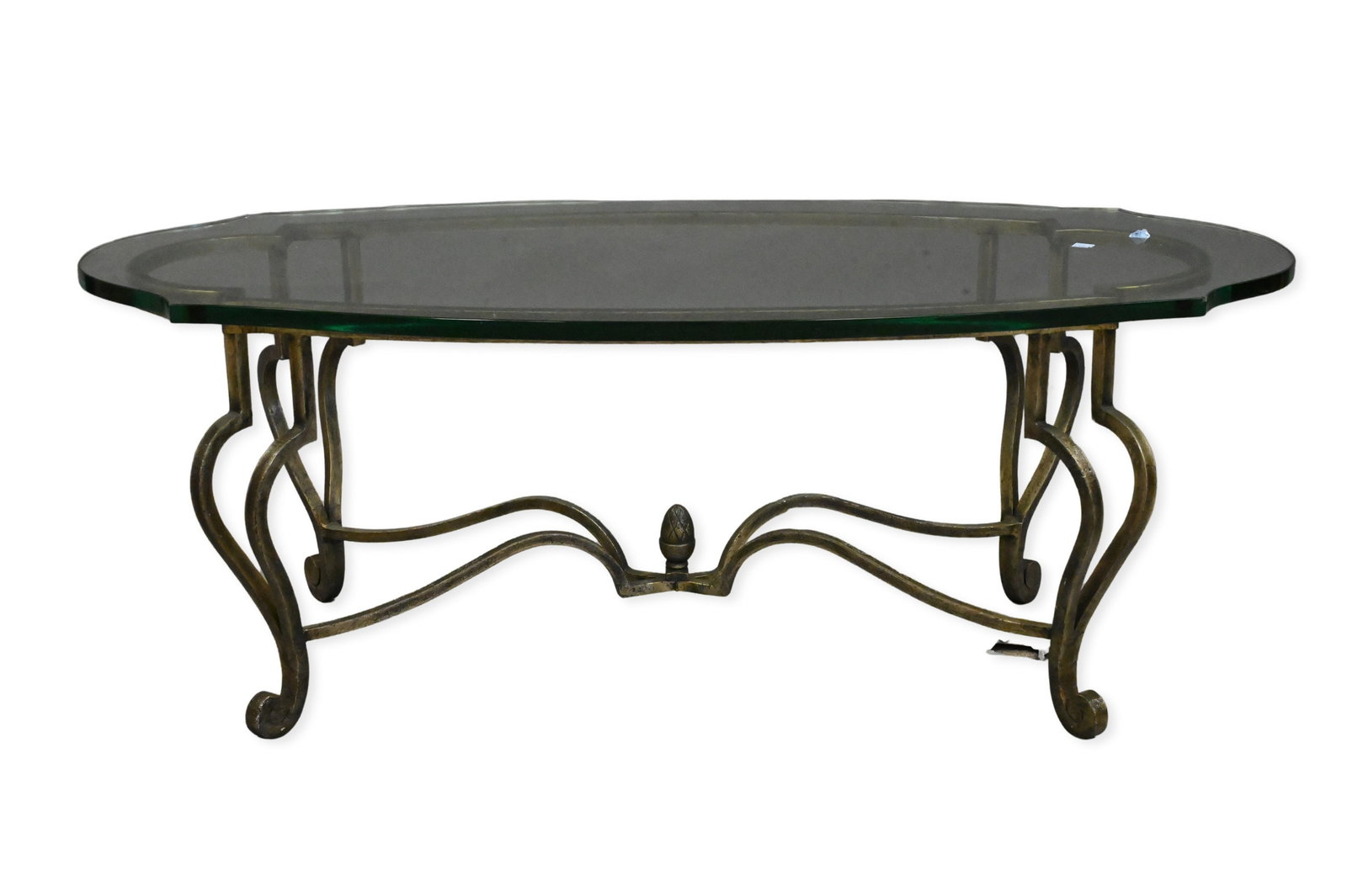 Oval Glass-Top Iron Coffee Table: Oval Glass-Top Iron Coffee Table having scrolling legs joined by curved stretchers and a central finial Height 17 inches, width 24 inches, length 48 inches