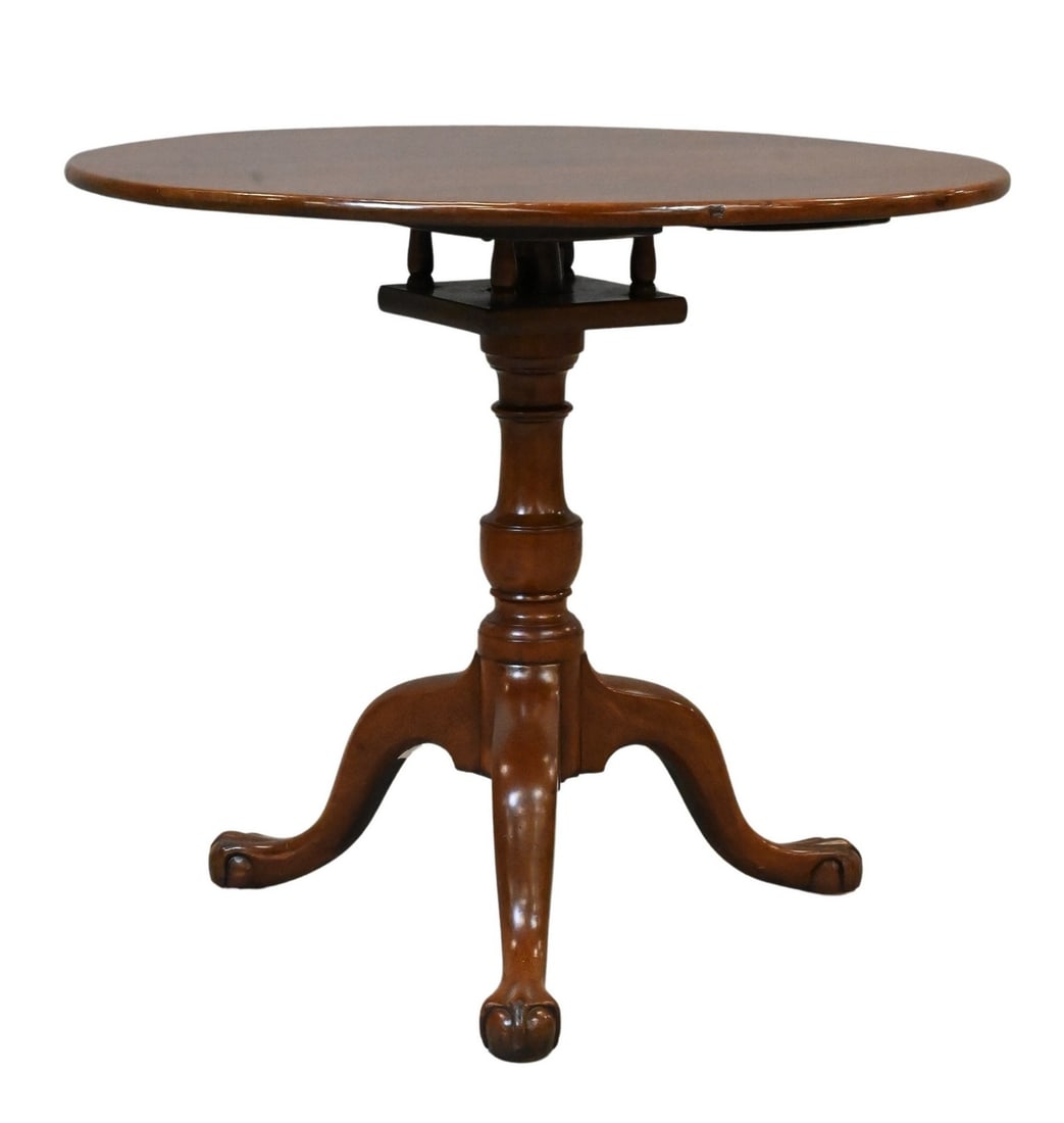 Chippendale Mahogany Circular Tilt-Top Tea Table: Chippendale Mahogany Circular Tilt-Top Tea Table the circular top tilting above a cage device on an urn stem and three cabriole legs, having ball and claw feet height 27 1/2 inches, diameter 32 inches