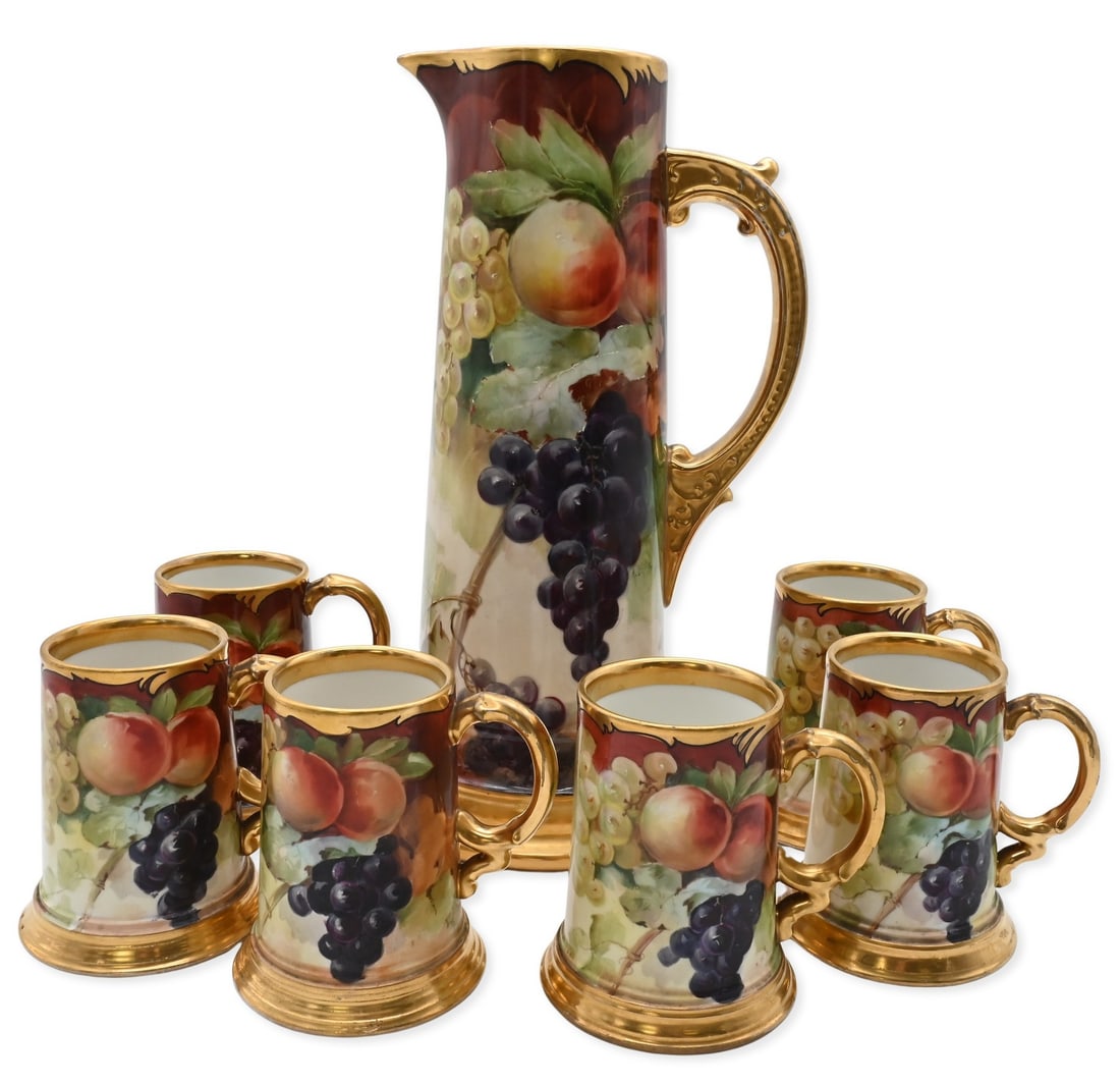 Seven Piece J.P. Limoges Porcelain Drinking Set: Seven Piece J.P. Limoges Porcelain Drinking Set decorated by grapes, peaches, and vine leaves against a shaded ground enriched by gilt accents, to include a tall tankard, height 15 inches, and six mat