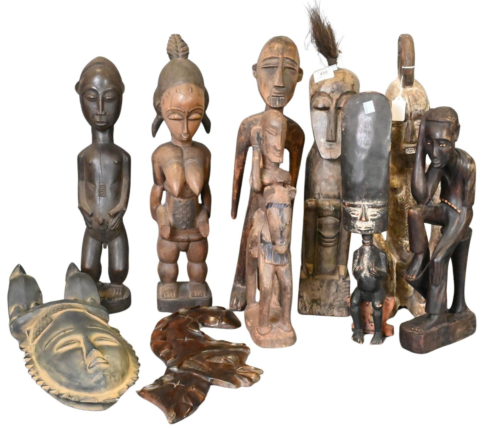Ten African Carved Wood Figures: Ten African Carved Wood Figures including standing male and female figures, mother and child, ancestor forms, fertility figures, and stylized tribal sculptures, carved in various hardwoods, attributed