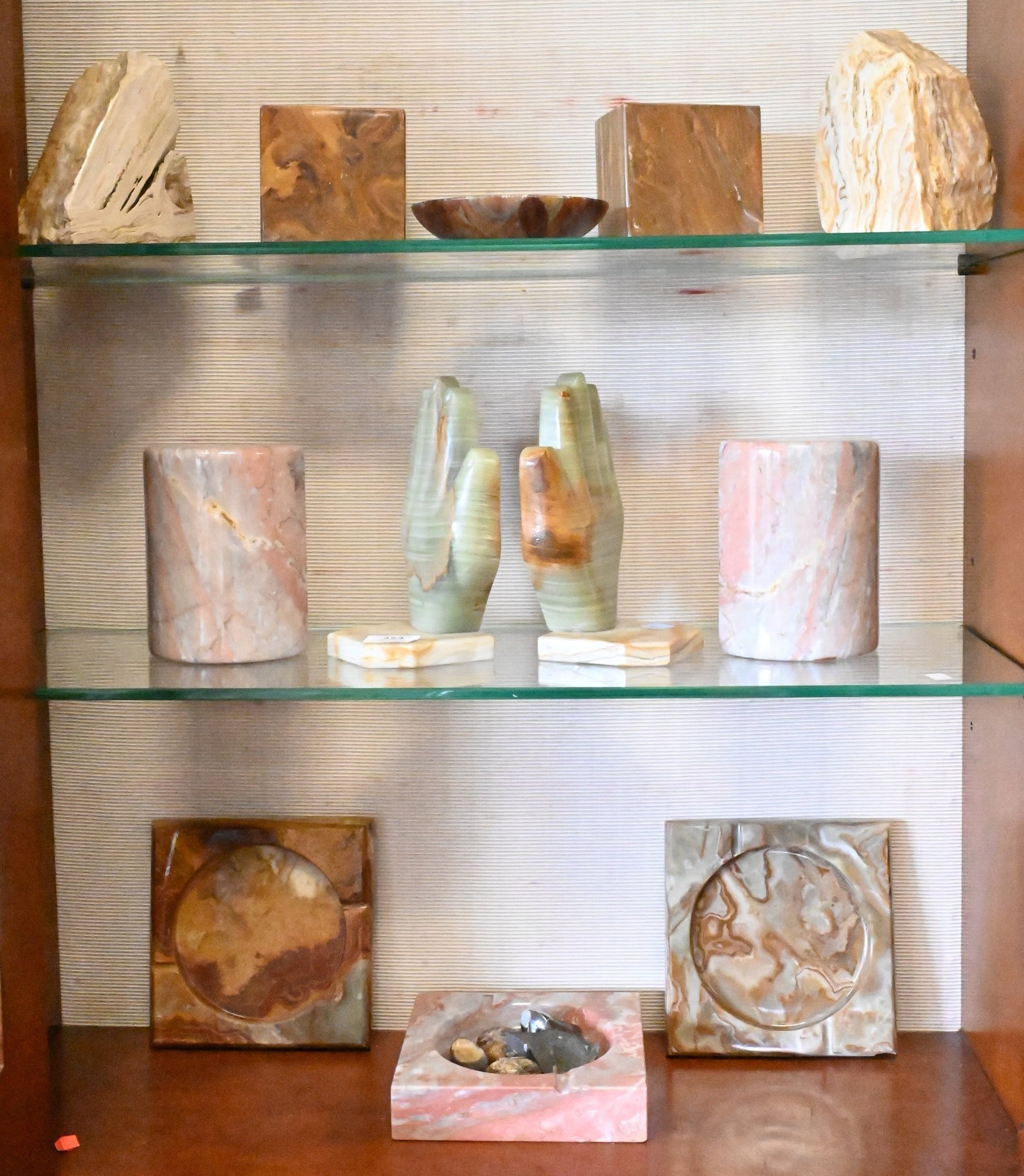 Group of Decorative Stone and Geode Articles: Group of Decorative Stone and Geode Articles including Art Deco hand shaped carved green onyx bookends, veined half moon Pakistani onyx bookends, polished natural form agate bookends, blue agate and m