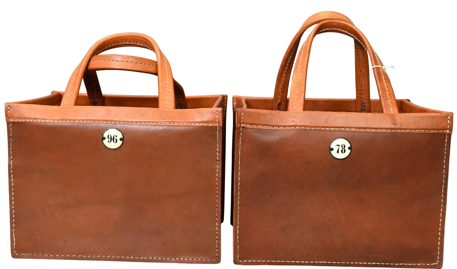 Pair of Leather Bocce Ball Tote Bags: Pair of Leather Bocce Ball Tote Bags having open interiors, double rolled handles, and numbered score medallions height including handles 20 inches, 10" x 15 1/2" bag