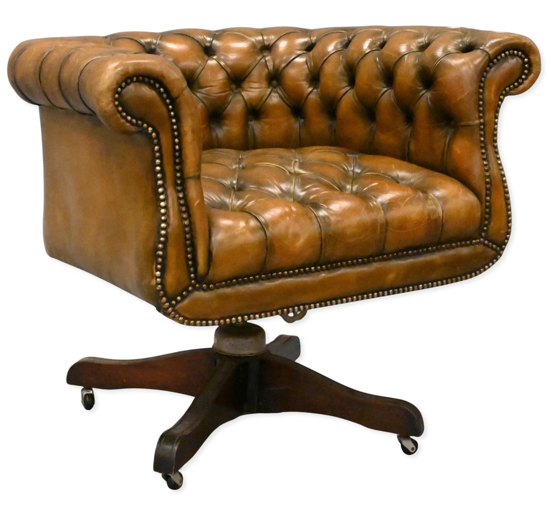 Chippendale Style Tufted Leather Library Chair: Chippendale Style Tufted Leather Library Chair having rolled arms and set on swivel base ending in casters height 27 inches, width 33 inches, depth 27 inches