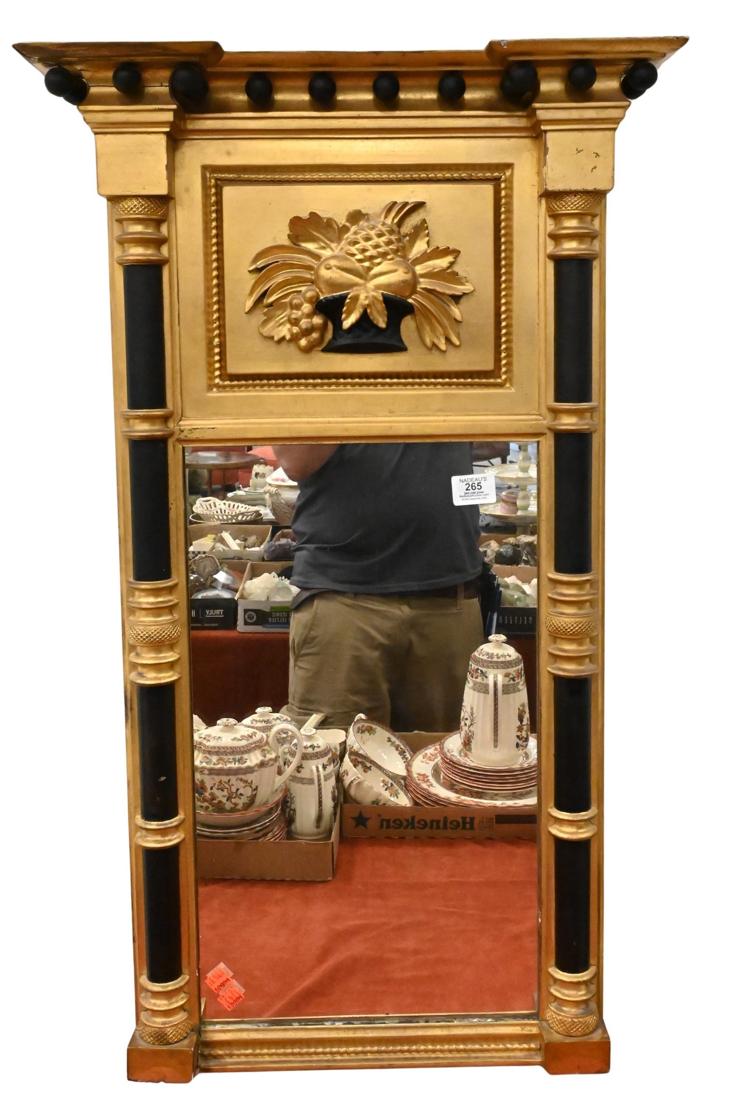 Federal Two Part Gilt and Ebonized Wood Mirror: Federal Two Part Gilt and Ebonized Wood Mirror Having a ball-form pediment above a carved fruit and floral panel, the mirror plate set within a gilt and ebonized wood frame, circa 1830 36" x 21"