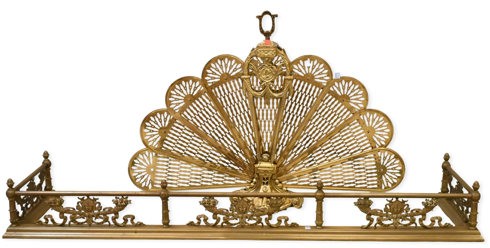 Two Piece Fireplace Accessory Group: Two Piece Fireplace Accessory Group to include Louis XV style brass fire fender decorated in fleur-de-lis and pineapple motifs; and a brass fan fireplace screen opening to reveal a pierced