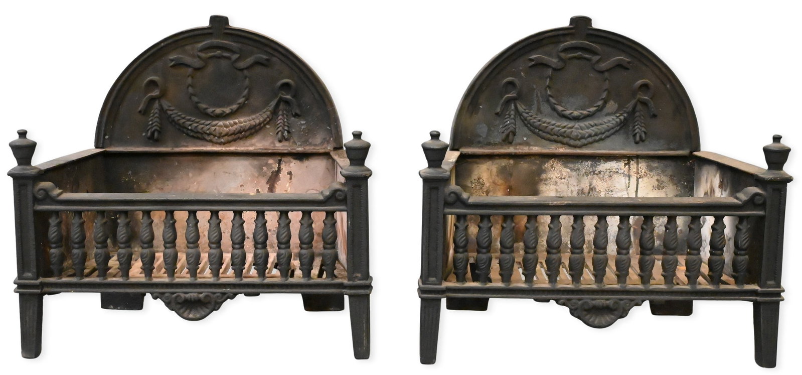 Pair of Victorian Iron Firegrates: Pair of Victorian Iron Firegrates each having wreath decorated backs height 20 inches, width 21 inches, depth 12 inches