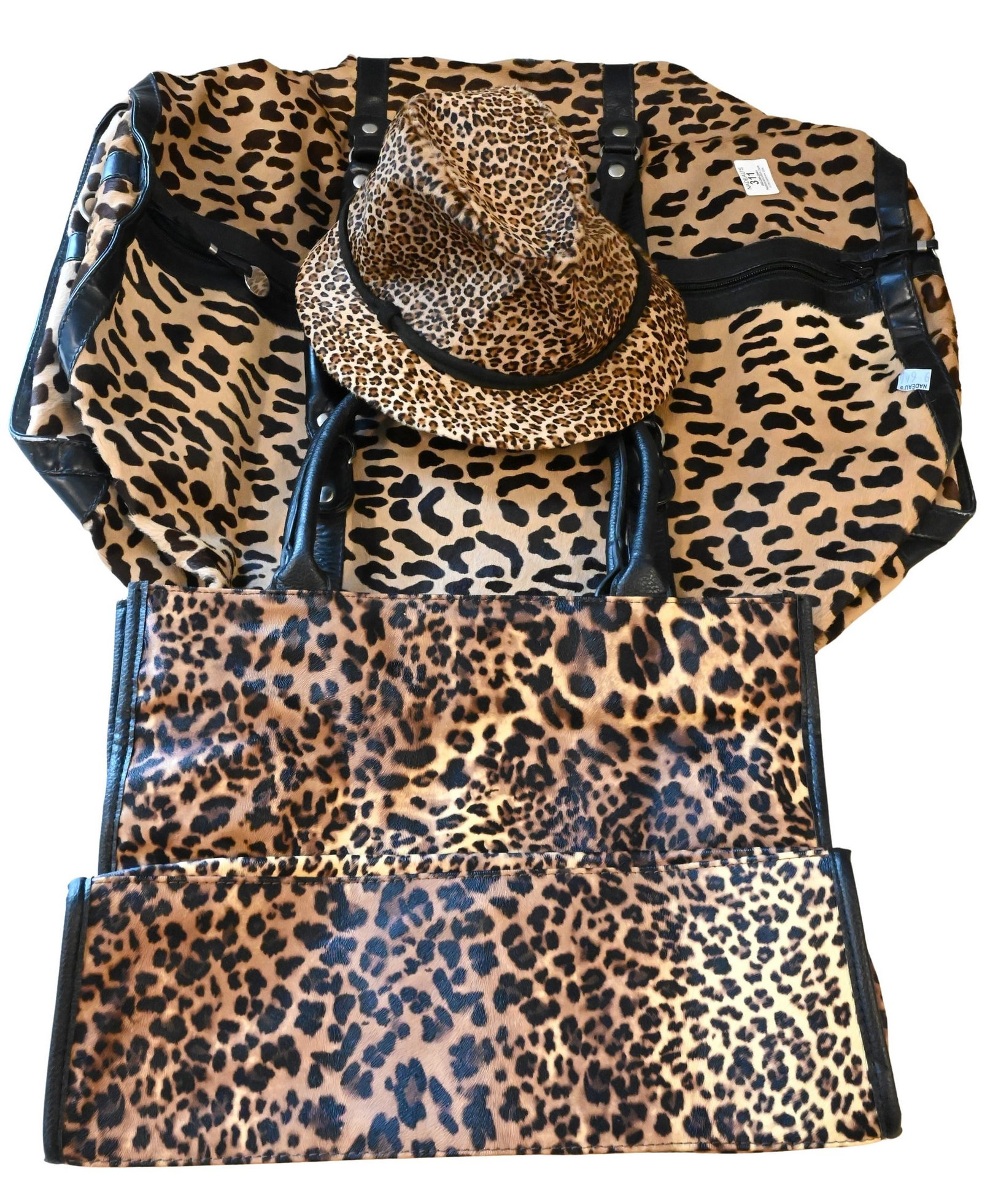 Two Vintage Designer Leopard-Print Bags and One Leopard Print Hat: Two Vintage Designer Leopard-Print Bags and One Leopard Print Hat To include a Maud Frizon leopard or cheetah print luggage bag having leather trim and handles 22" x 24", together with a Neiman