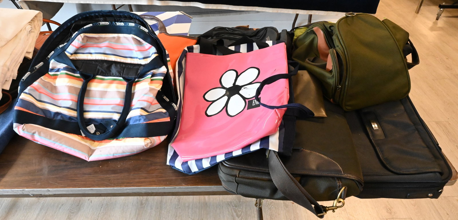 Group of Tote Bags, Computer Cases, and Travel Bags: Group of Tote Bags, Computer Cases, and Travel Bags To include an ICON computer bag, Targus laptop case, Hartmann canvas bag, LeSportsac striped travel tote, ENK tote bag, AmeriBag sling bags, and