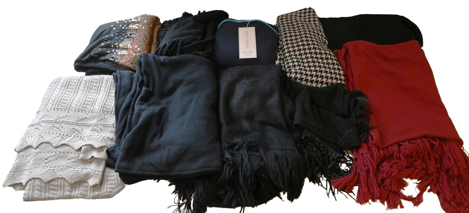 Group of Nine Women's Shawls and Wraps: Group of Nine Women's Shawls and Wraps To include knit shawls, wraps, and reversible travel piece, in wool and blended fabrics, including houndstooth, cable knit, and solid examples, some having