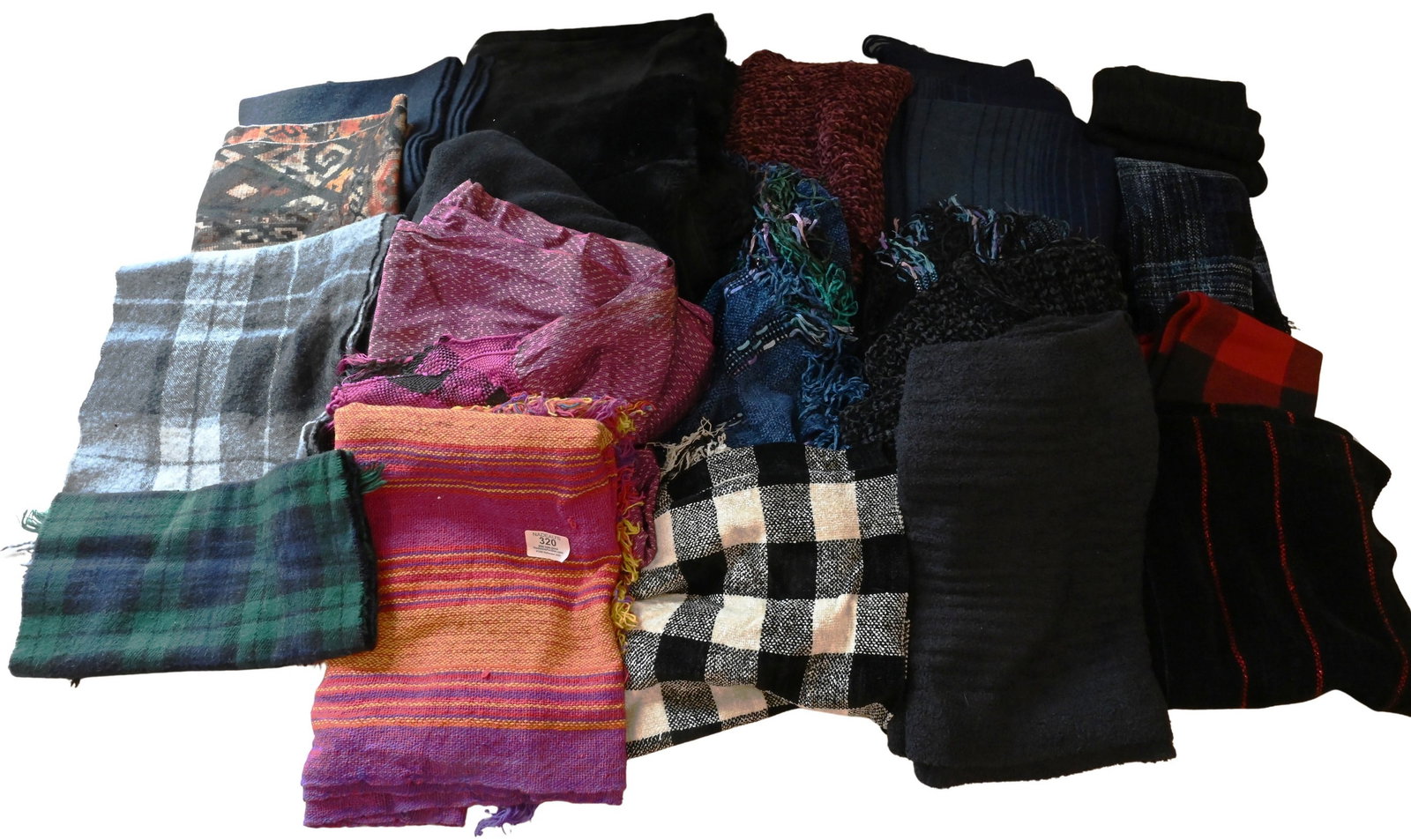 Group of Knit and Blend Scarves and Shawls: Group of Knit and Blend Scarves and Shawls To include knit scarves and shawls in cotton and blended fabrics, decorated with striped, plaid, heathered, and solid designs, some having fringe trim