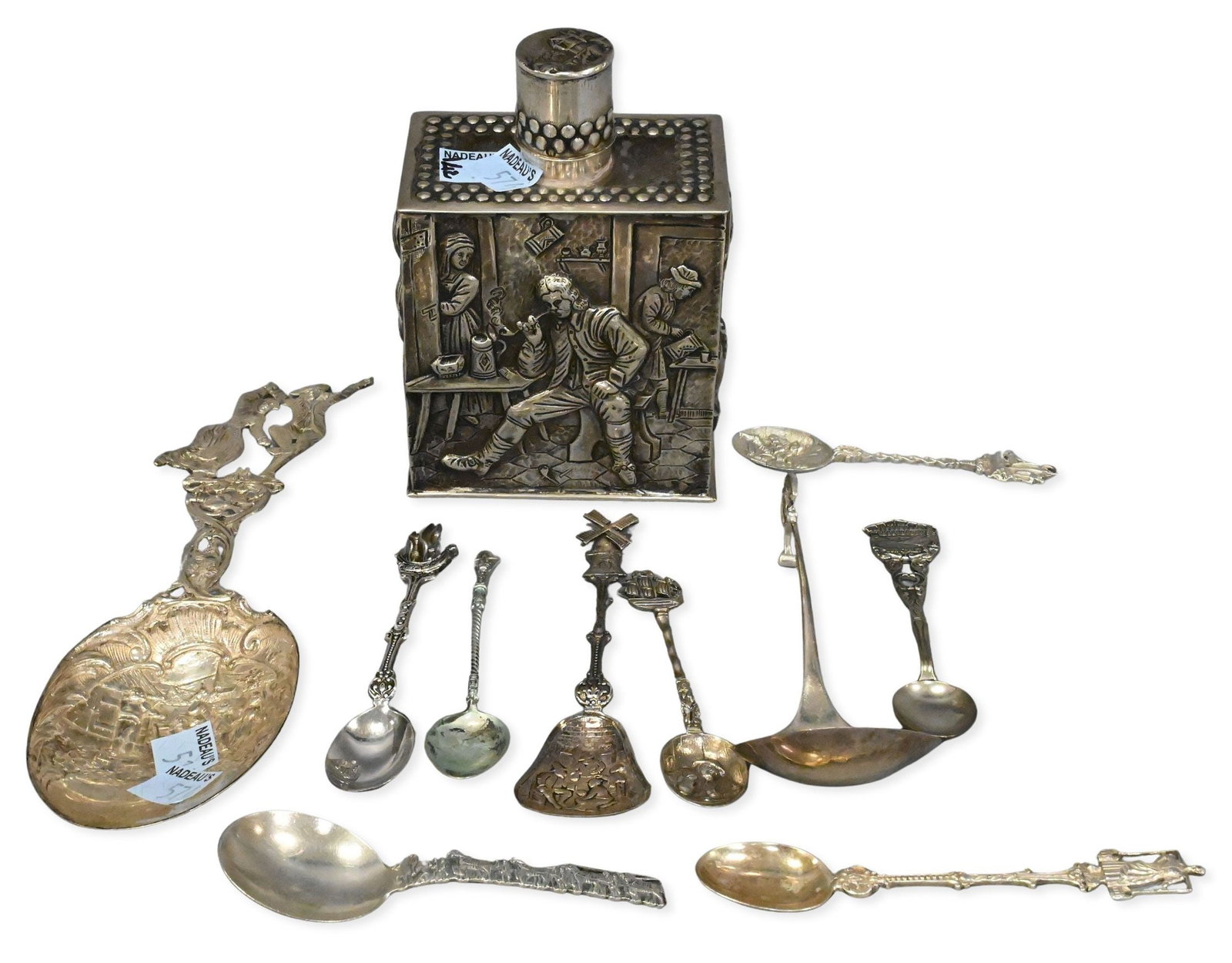 Group of Continental Silver: Group of Continental Silver to include Dutch repousse tea caddy, along with several highly decorated spoons tallest 5 inches, 13.3 troy ounces Provenance: From a Briarcliff Manor Estate