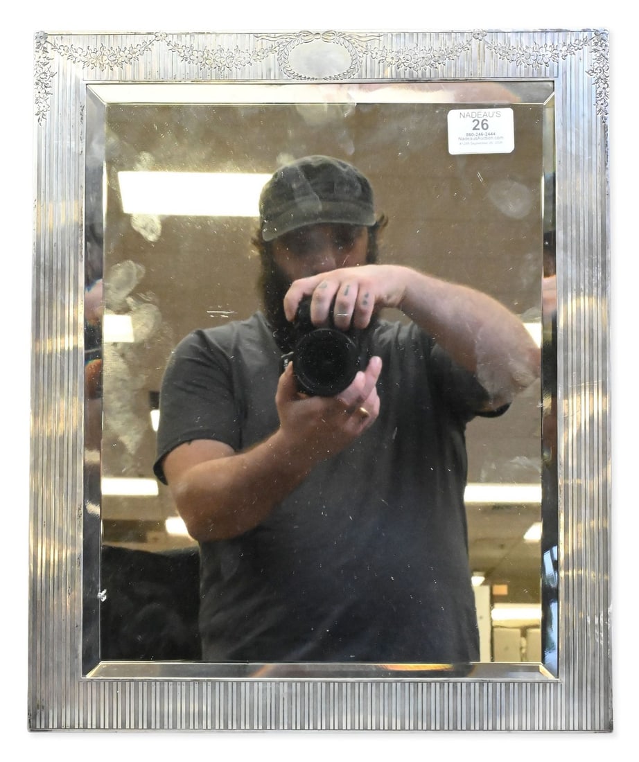 Hodgson and Kennard Sterling Vanity Mirror: Hodgson and Kennard Sterling Vanity Mirror set in reeded silver frame with floral swag, bow, and oval cartouche decoration 16" x 13 1/2" Provenance: From a Briarcliff Manor Estate