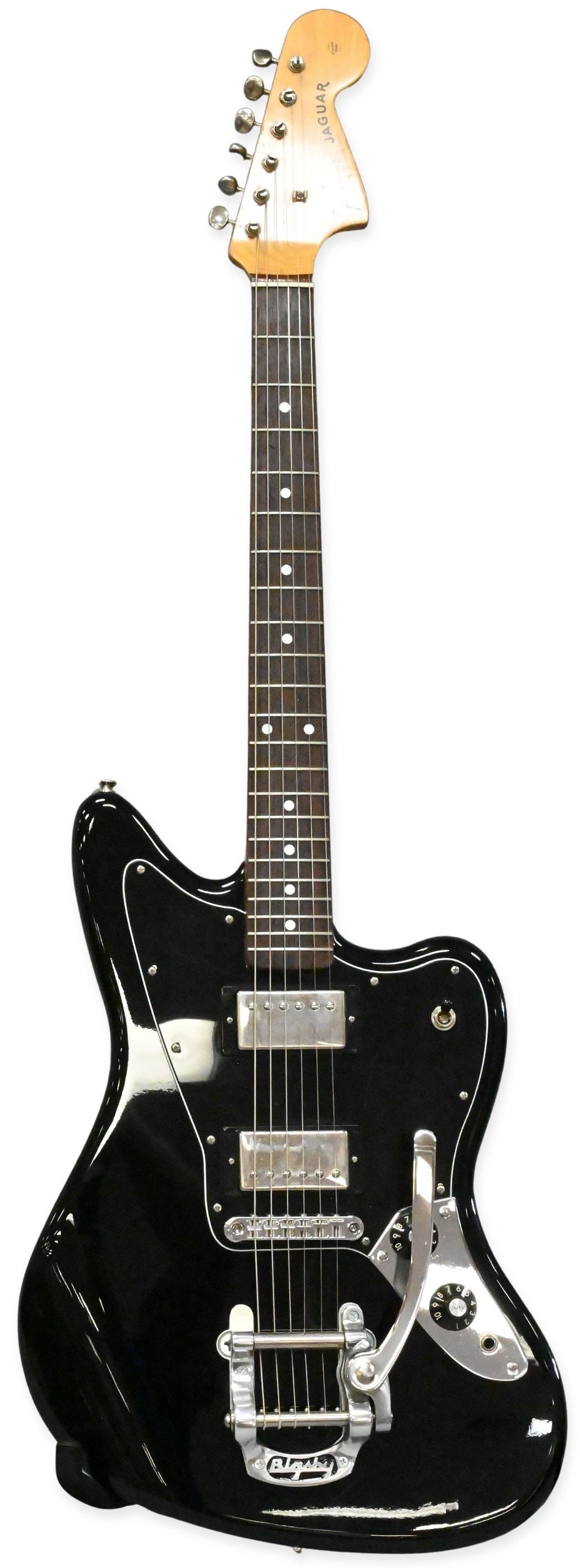 Fender Jaguar Electric Guitar: Fender Jaguar Electric Guitar having black lacquer finish, made in Japan, serial number V038054. Along with hard case
