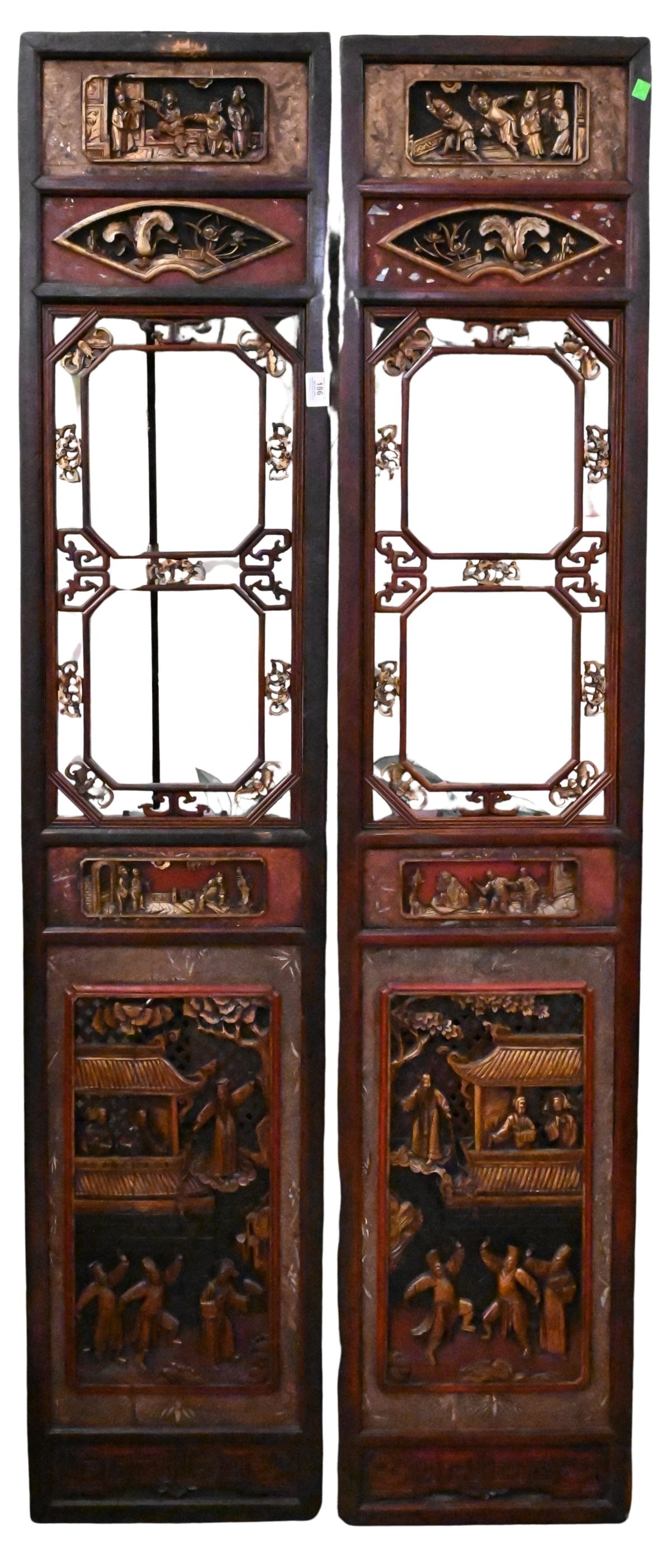 Pair of Chinese Carved Wood Panels: Pair of Chinese Carved Wood Panels Each tall rectangular panel having openwork geometric lattice centers, carved and gilt-highlighted scrollwork, above and below relief-carved figural scenes within