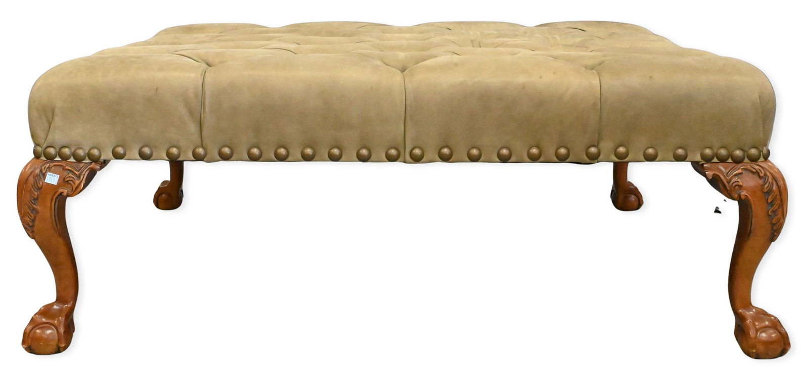 Tufted Ottoman: Tufted Ottoman having tack motif to bottom edge and set on boldly carved cabriole legs ending in ball and claw feet height 19 inches, top 37" X 49"