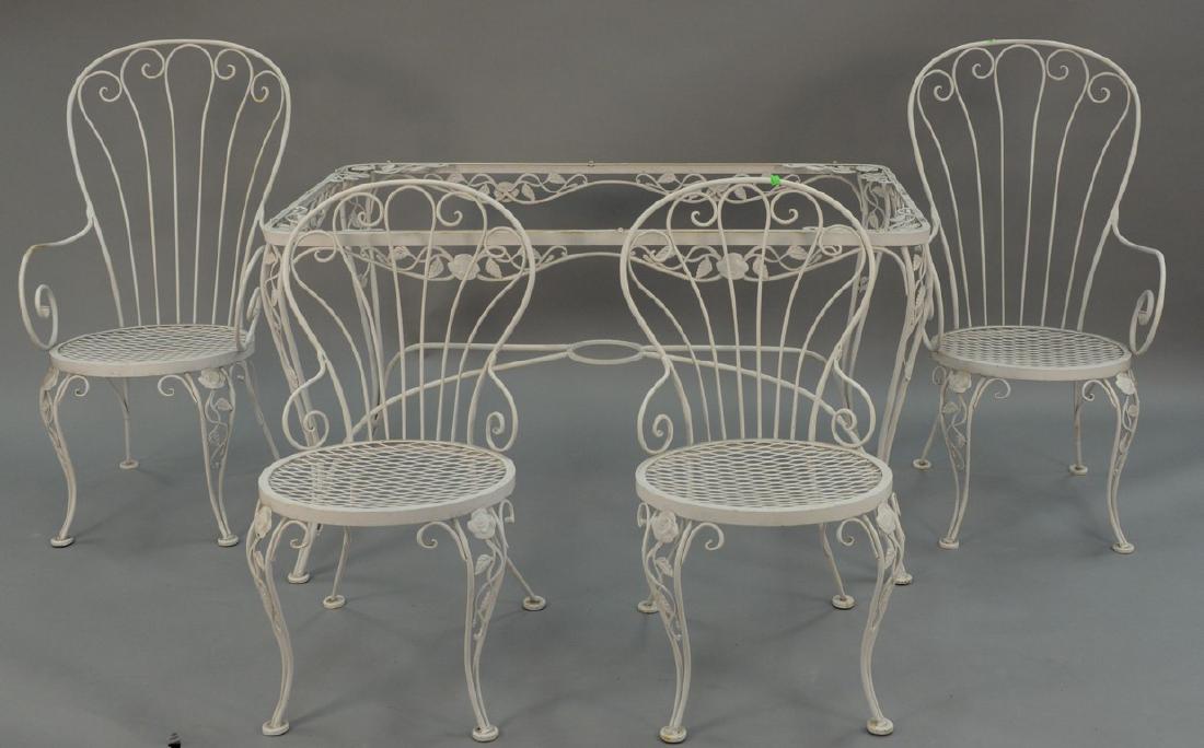 Iron table and four chairs, two arm and two side. top:: Iron table and four chairs, two arm and two side. top: 31" x 51".